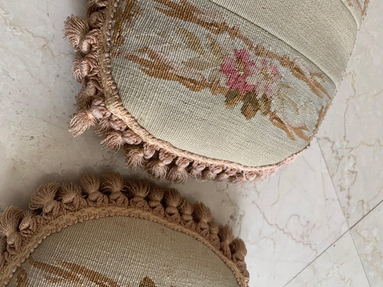 A pair of French Provincial Aubusson pillows from the 19th century, with foliage decor and petite tassels that will brighten up any sofa, canapé or settee! They are in excellent condition with gold backing and tassels. They each measure 9 inches