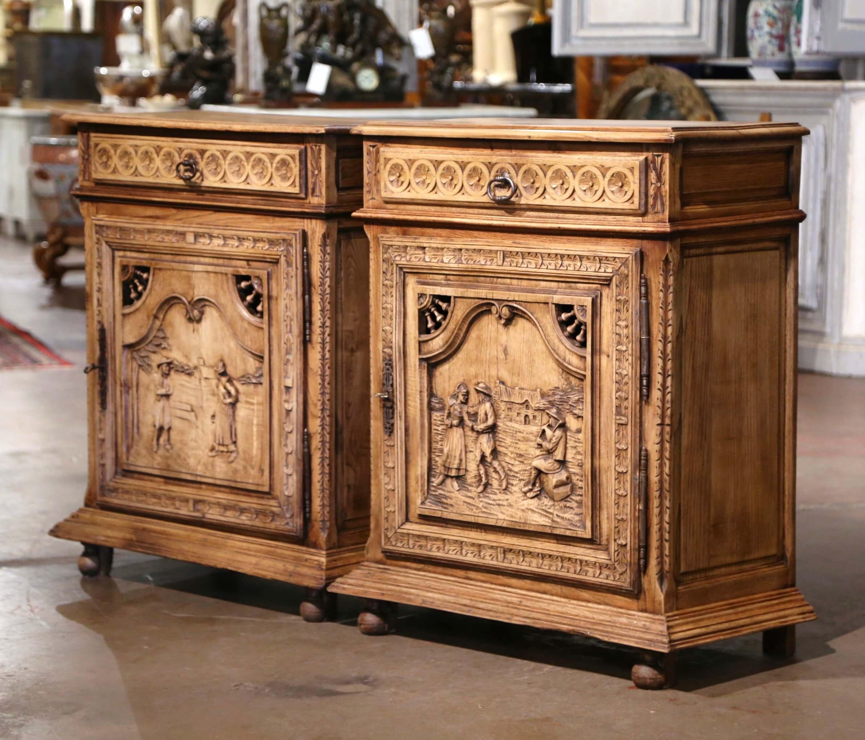 Decorate an entryway, library, or study with this elegant pair of antique “confituriers” (French for jelly cabinets). Crafted in Brittany, France circa 1870, each cabinet is built from a mix of solid oak and chestnut and stands on bun feet over a