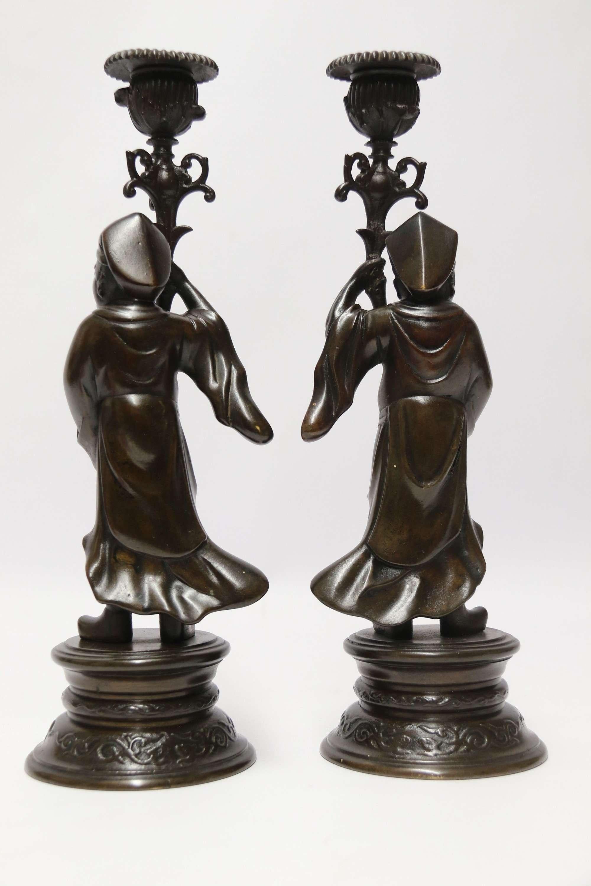 A Good Pair of 19th C French Bronze Candlesticks in the form of Chinese Figures

A most unusual good quality French bronze candlesticks in the form of 18th-century Chinese male figures dressed in traditional costume and holding up torchieres which