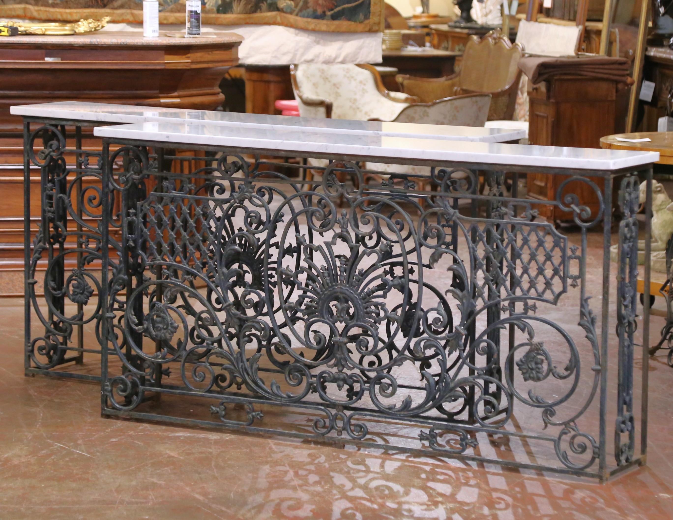Elevate your space with this elegant pair of antique French consoles. Crafted circa 1870 in the Louis XV style from repurposed balcony grilles, the wrought iron bases feature intricate hand-forged scrollwork, stylized acanthus flourishes, trellis