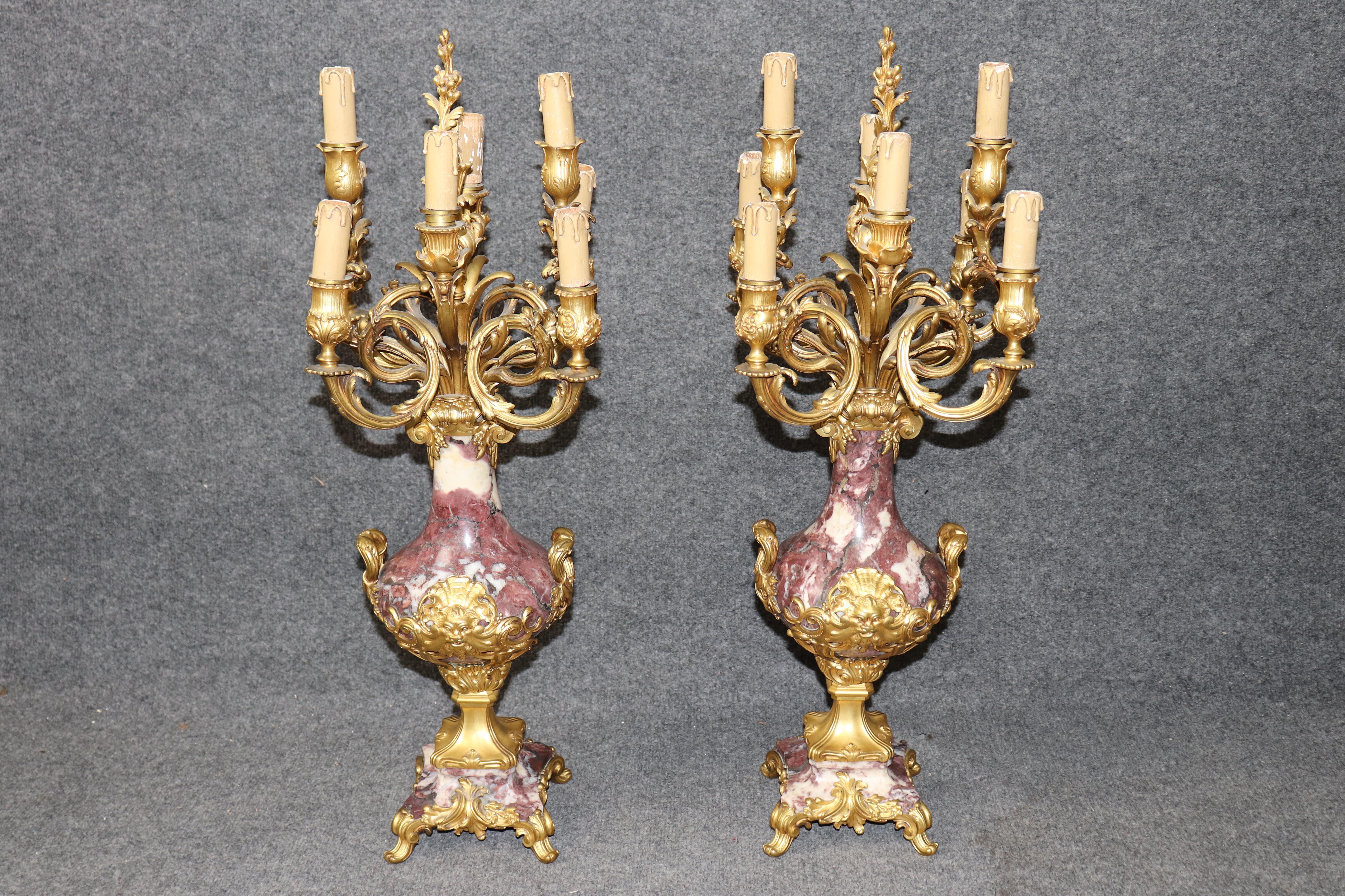 Dimensions - H: 29 1/2 in W: 12 3/4 in D: 12 3/4 in

A magnificent pair of 19th century French Louis XV style bronze mounted candelabras, masterfully executed by the esteemed foundry Susse Frères, and mounted on rare and highly decorative Breche