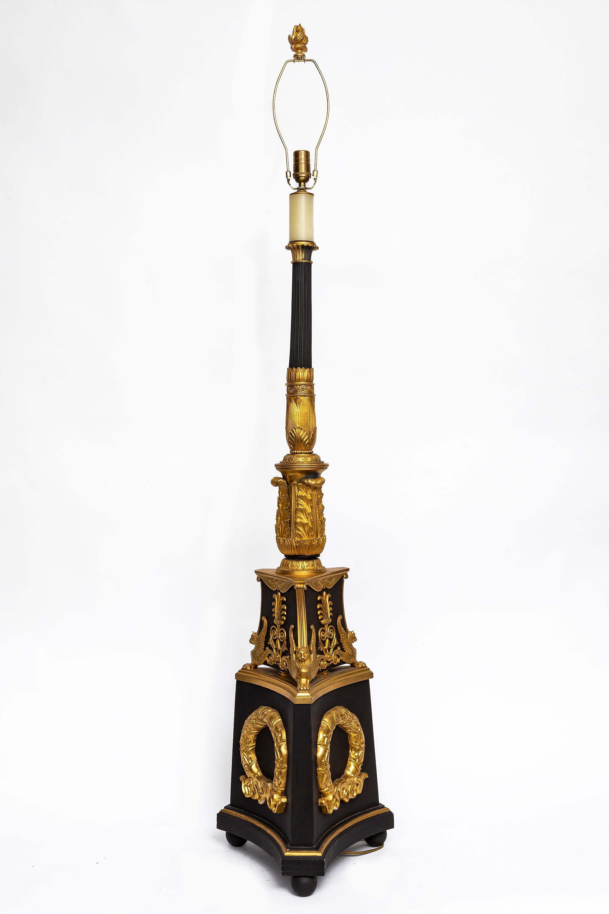 Incroyable et grande paire de torchères montées en bronze patiné et bronze doré de la période Empire française du 19e siècle.  La base en bronze patiné est ornée de montures en bronze doré, ciselées et gravées à la main, qui présentent une