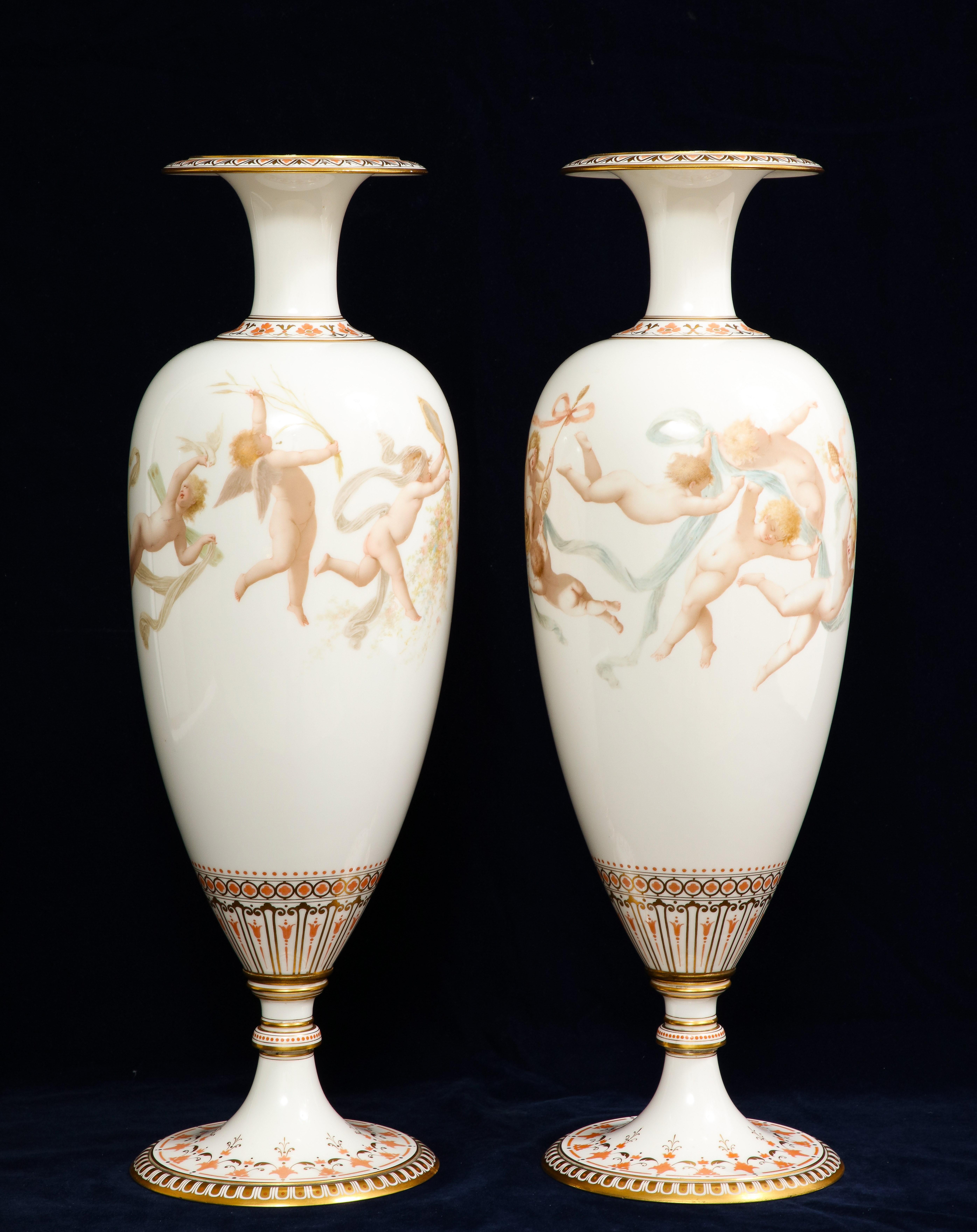 A Magnificent Pair of 19th Century French Marked Sevres Porcelain Vases with Cupids, Signed E. Sieffert. This pair of Signed and Marked Sevres vases are truly beautiful with hand-painted cupids in an array of poly-chrome colors. Each cupid is