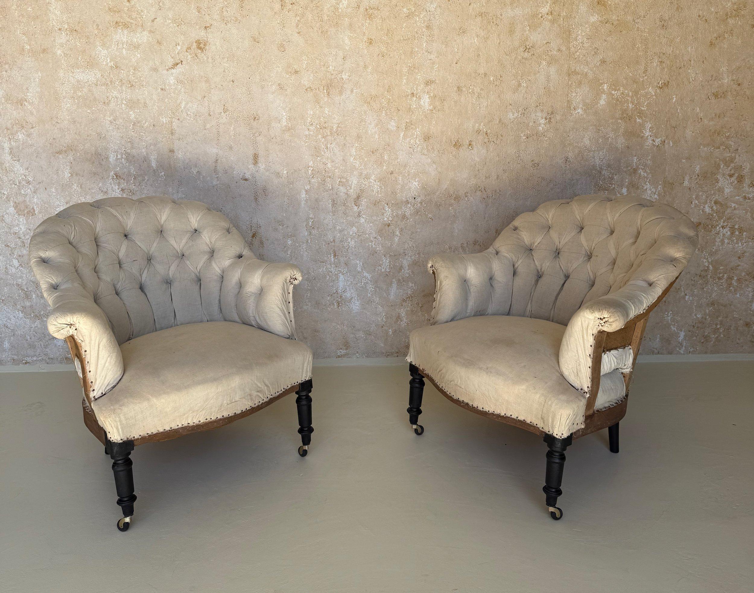 An elegant pair of French 19th century small scale Napoleon III style armchairs with gracefully flared arms, classically rounded backs with diamond tufting and delicately turned legs.

These French Napoleon III small scale armchairs feature