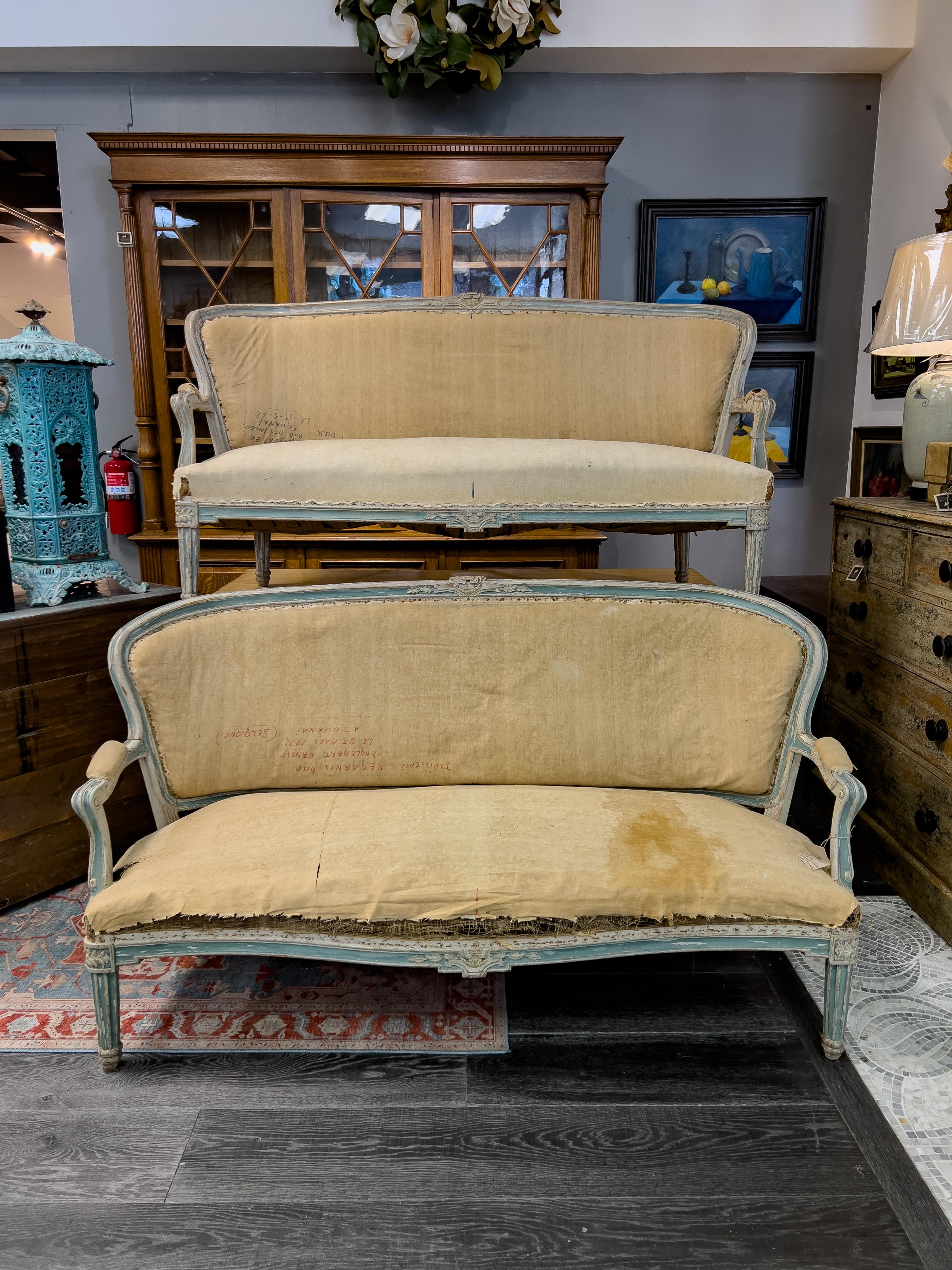 Pair of 19th c. French transitional style sofas, having reeded Louis XVI style legs and curved Louis XVI back and arms. Original horse hair and spring construction.