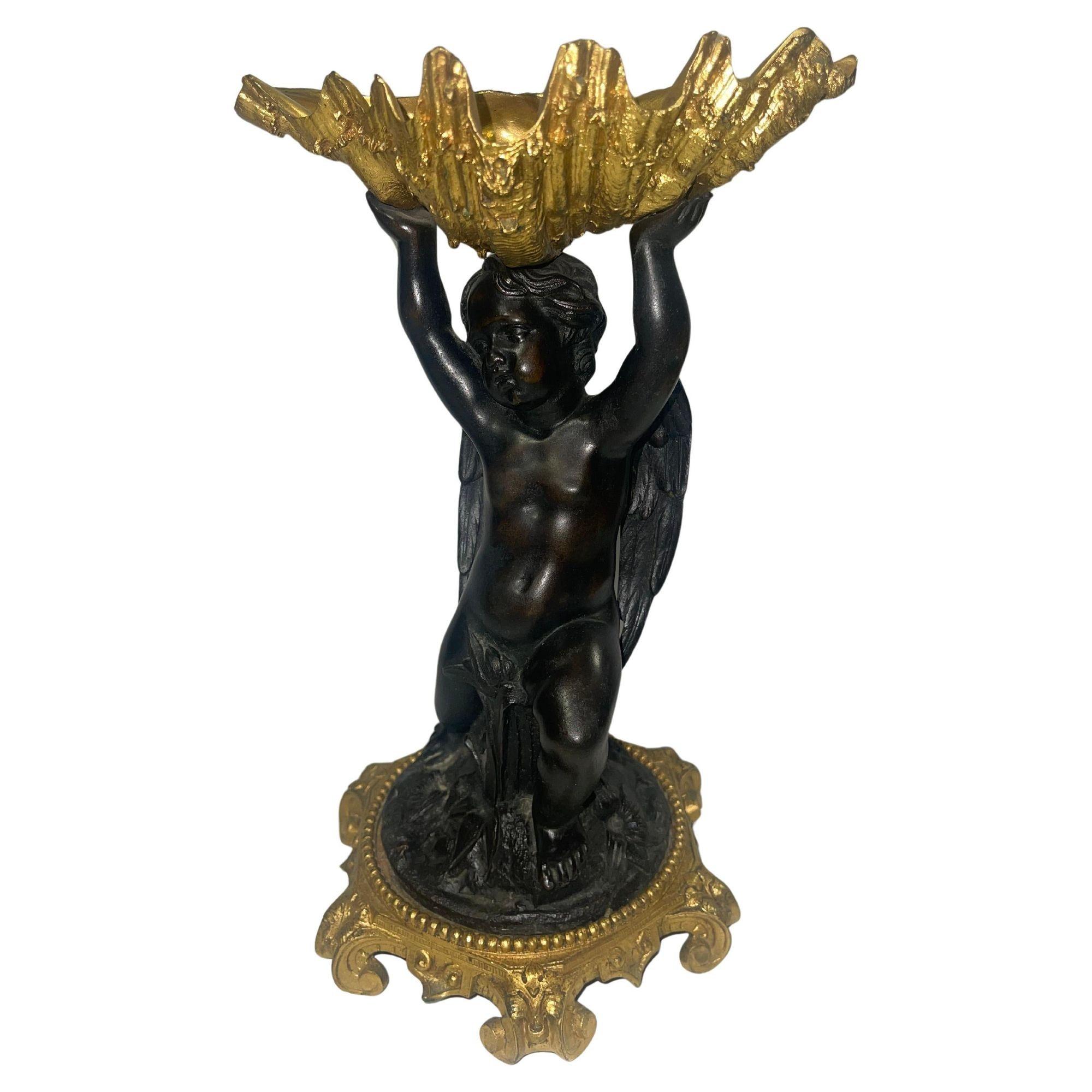This elegant pair of 19th-century French gilt bronze garnitures features shell-form bowls gracefully supported by finely detailed angelic figures. Crafted with exceptional artistry, each bowl rests delicately within the angels’ outstretched arms,
