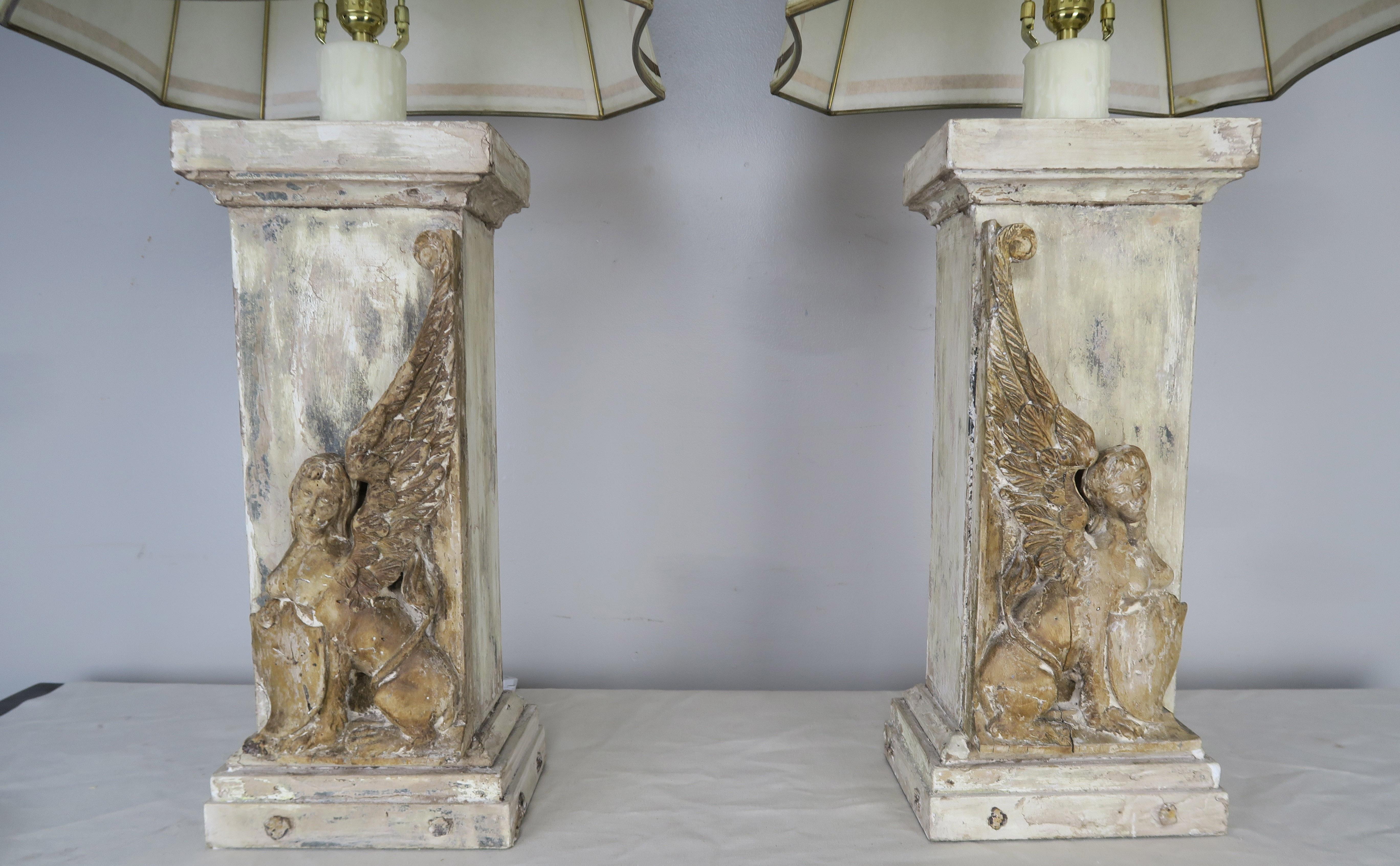 Pair of custom painted lamps made with 19th century carved wood sphinx combined with reclaimed wood to create a one-of-a-kind pair of lamps. The lamps are crowned with custom hand painted parchment shade that coordinate perfectly with the bases. The