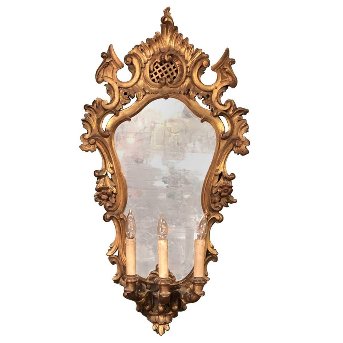 Pair of 19th century carved Italian Three light mirrored sconces. Also known as the Late Baroque period, is defined as a highly ornamental quality with an ethereal touch. Common elements include scrolling curves, gilding, pastel hues, sculpted