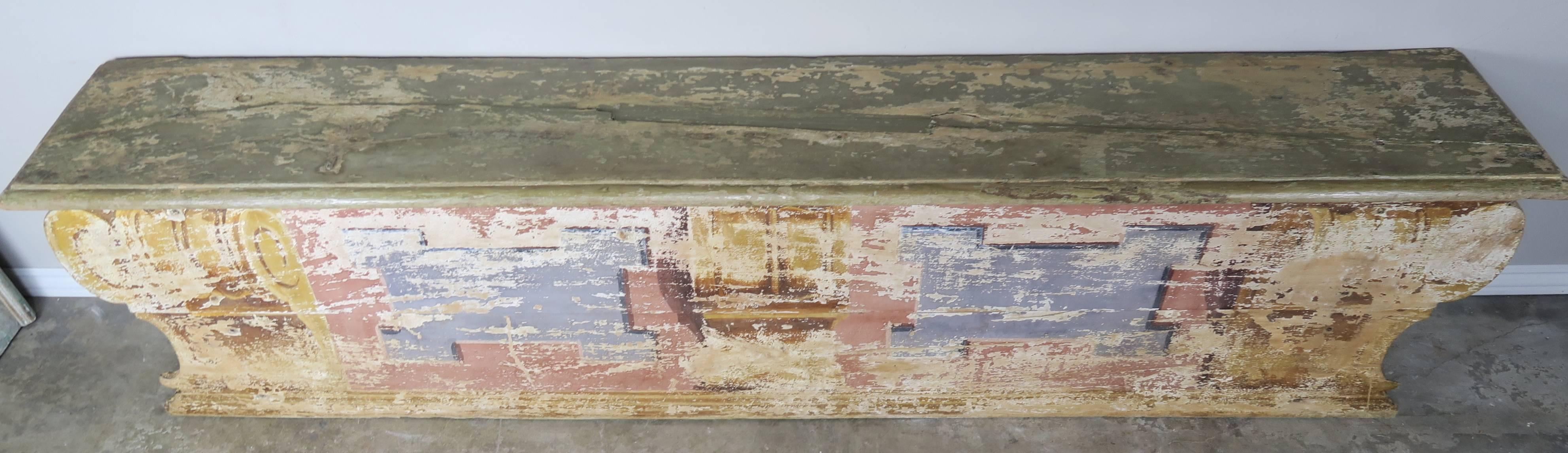 Pair of 19th century Italian painted benches. The seat on one bench opens to storage underneath. The second bench is simply a bench. They are a matching pair except for the storage area and would be beautiful flanking a dining table.