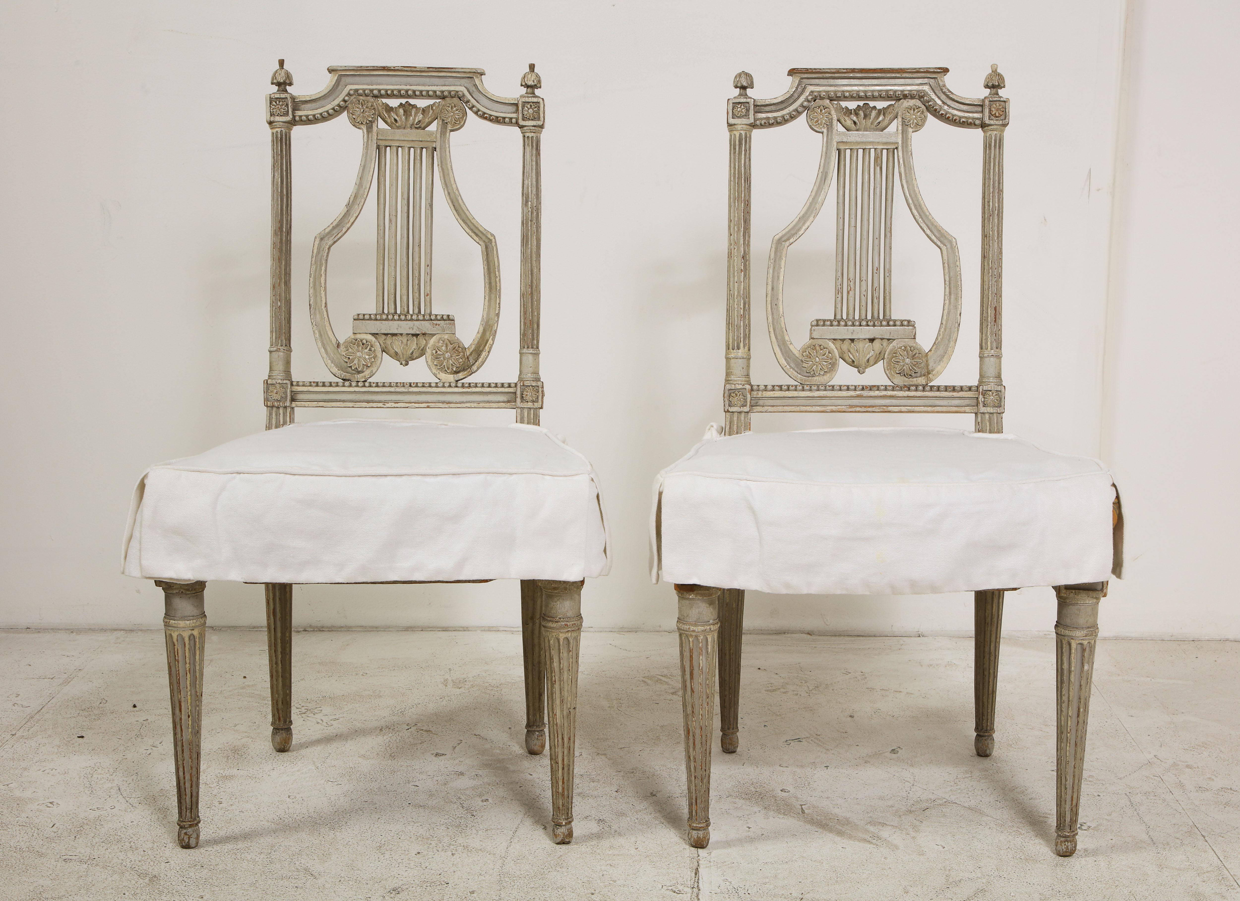 Pair of 19th century Italian painted lyre-back side chairs. Welted seat cushions in Fortuny Damask fabric, also with white cotton slipcovers.