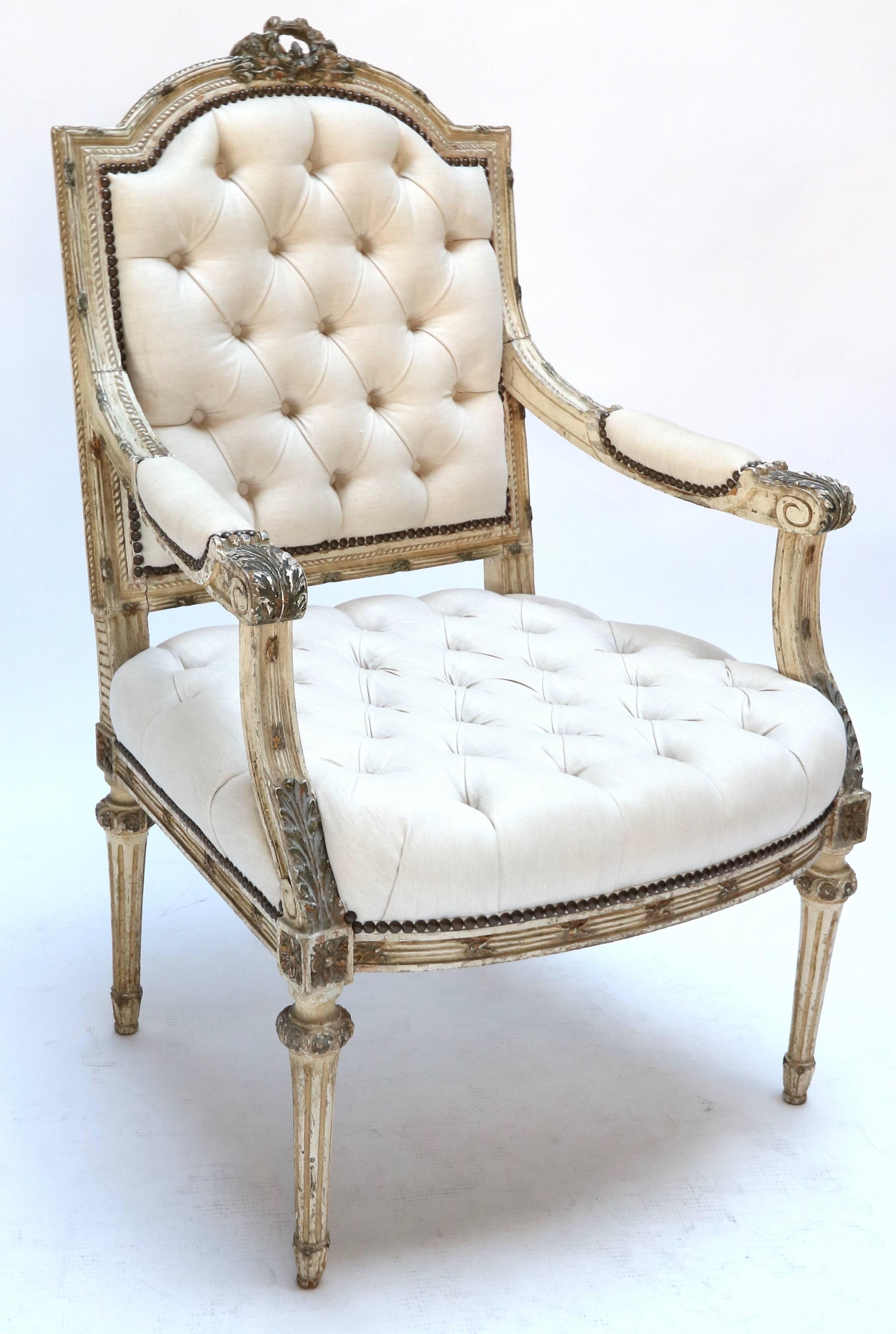 Pair of beautifully carved white Louis XVI style armchairs, upholstered in beige linen.