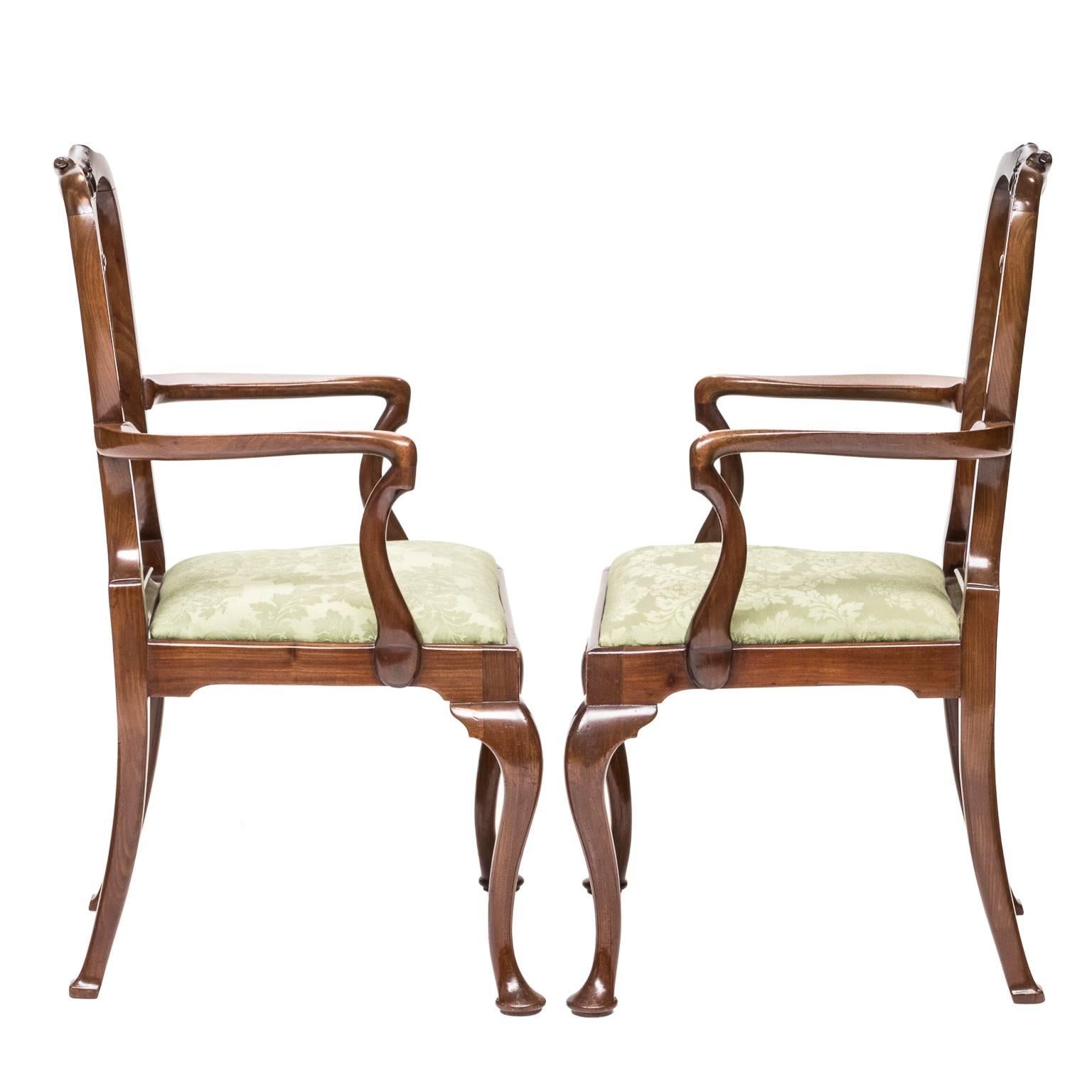 Pair of 19th century Queen Anne walnut child's armchairs. Small in scale and collectible. Shepard's crook arms, urn-shaped splat, a swag of tassels carved on the crest of the chair, cabriole legs and resting on pad feet.