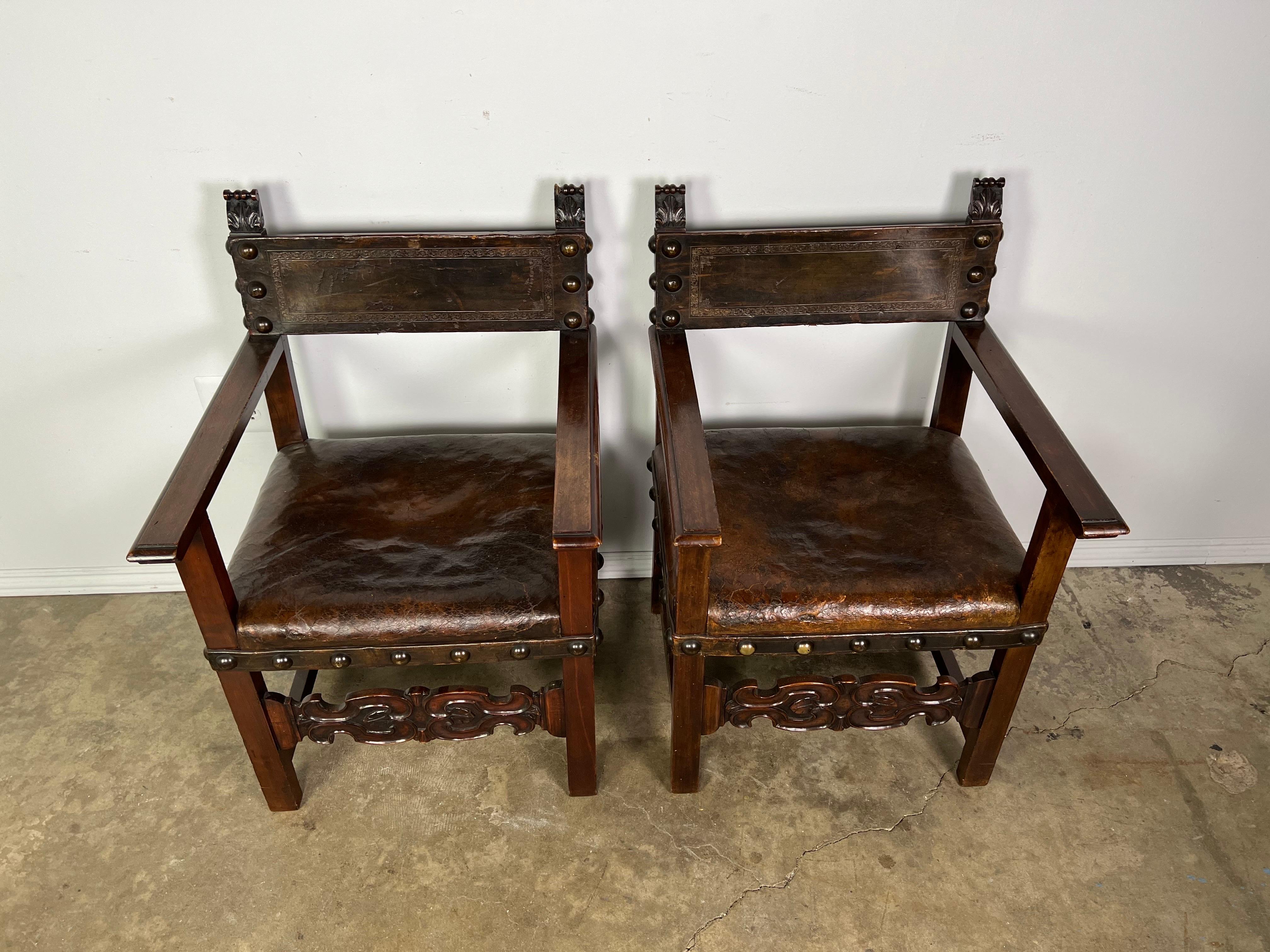 Pair of 19th C. Spanish Baroque style leather upholstered walnut armchairs. Original brass nailhead trim detail.