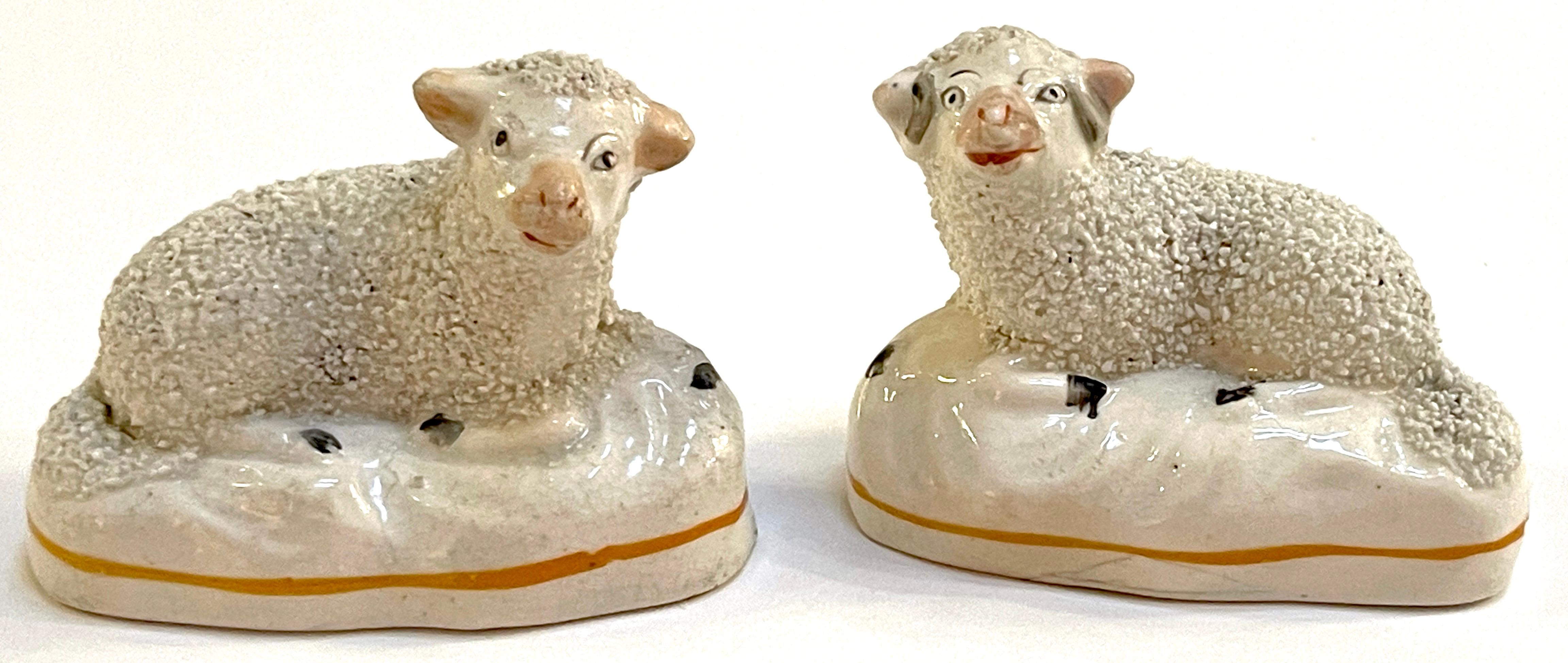 Pair of 19th century Staffordshire figures of Recumbent Sheep.
England, circa 1860s.

A diminutive pair of expressive pair of Staffordshire pottery sheep with textured bodies. Some firing lines, structurally sound.