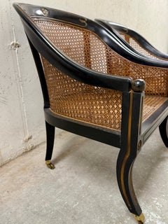 Paire de chaises à roulettes en bois ébonisé et cannage de style Régence française du C.I.C.