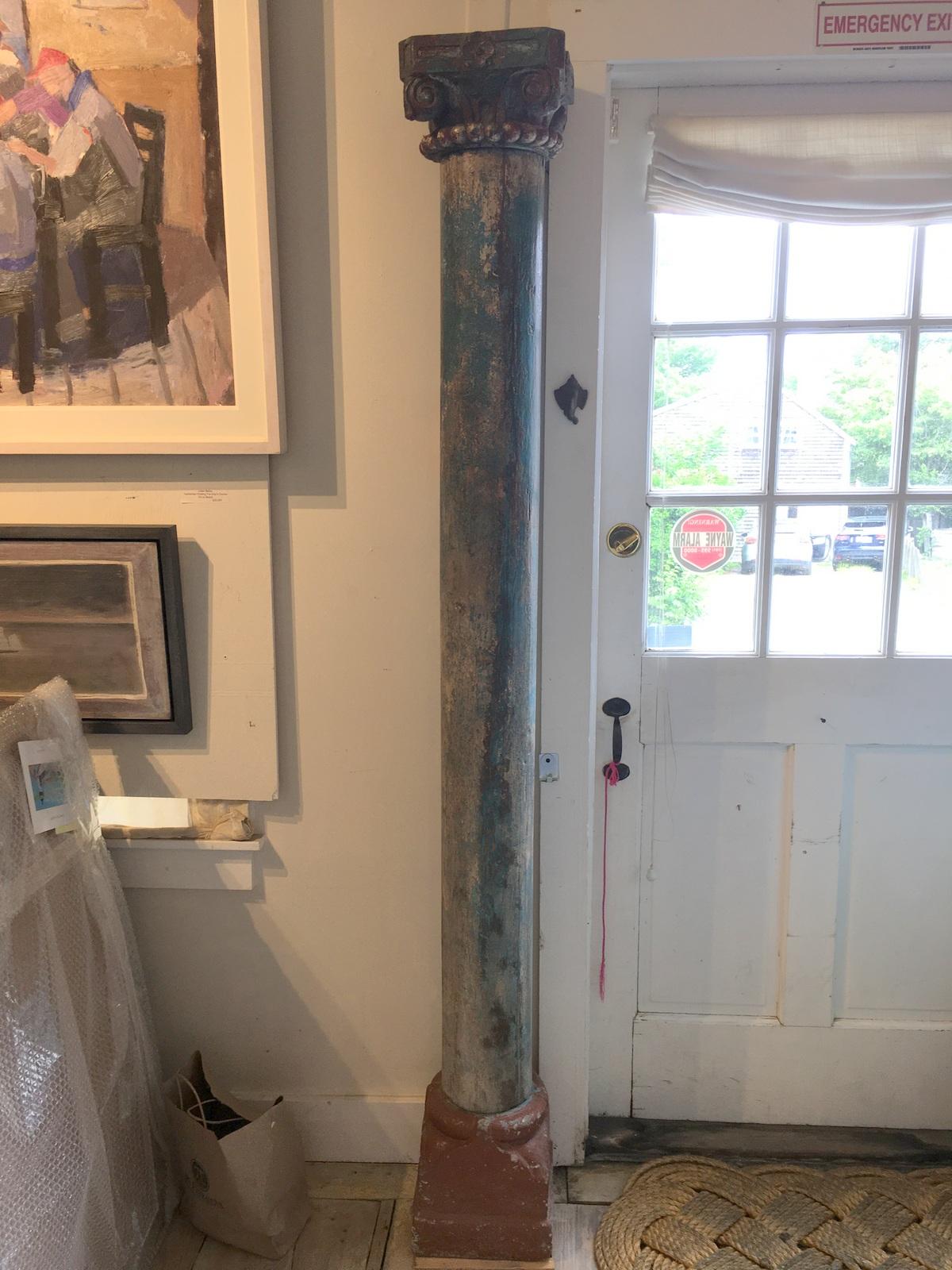 Rescued from an Indian interior courtyard, a pair of solid teak columns with their original paint in hues of blue and green with traces of white. Separate capitals and stone bases. You can see that one base must have been up close against the wall