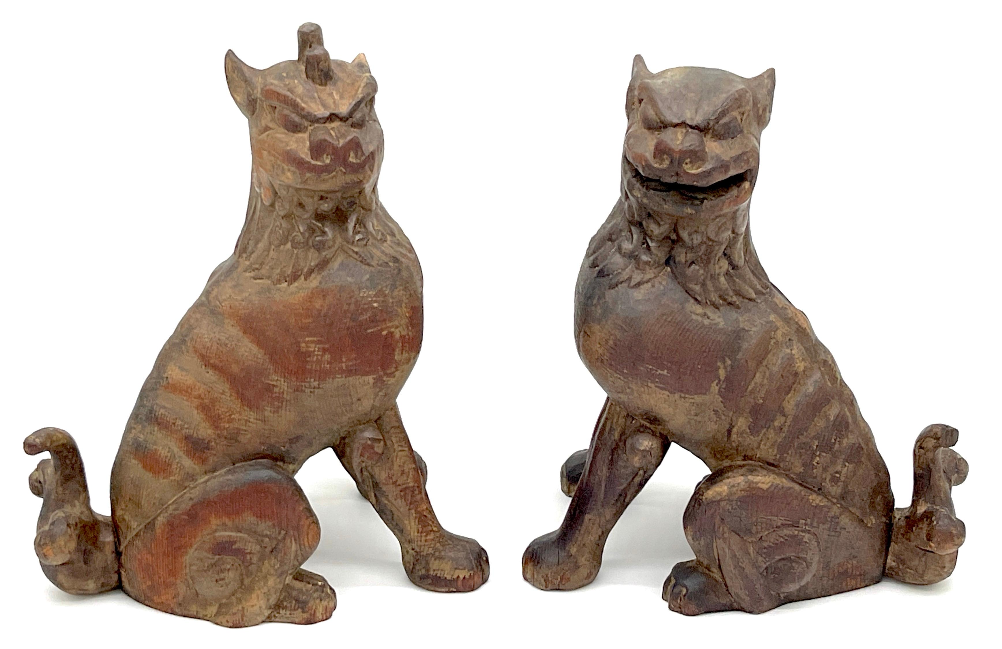 A unique and enchanting pair of 19th Century Tibetan carved wood & polychromed foo/guardian/temple dogs. These mythical Buddhist temple dogs, also known as 