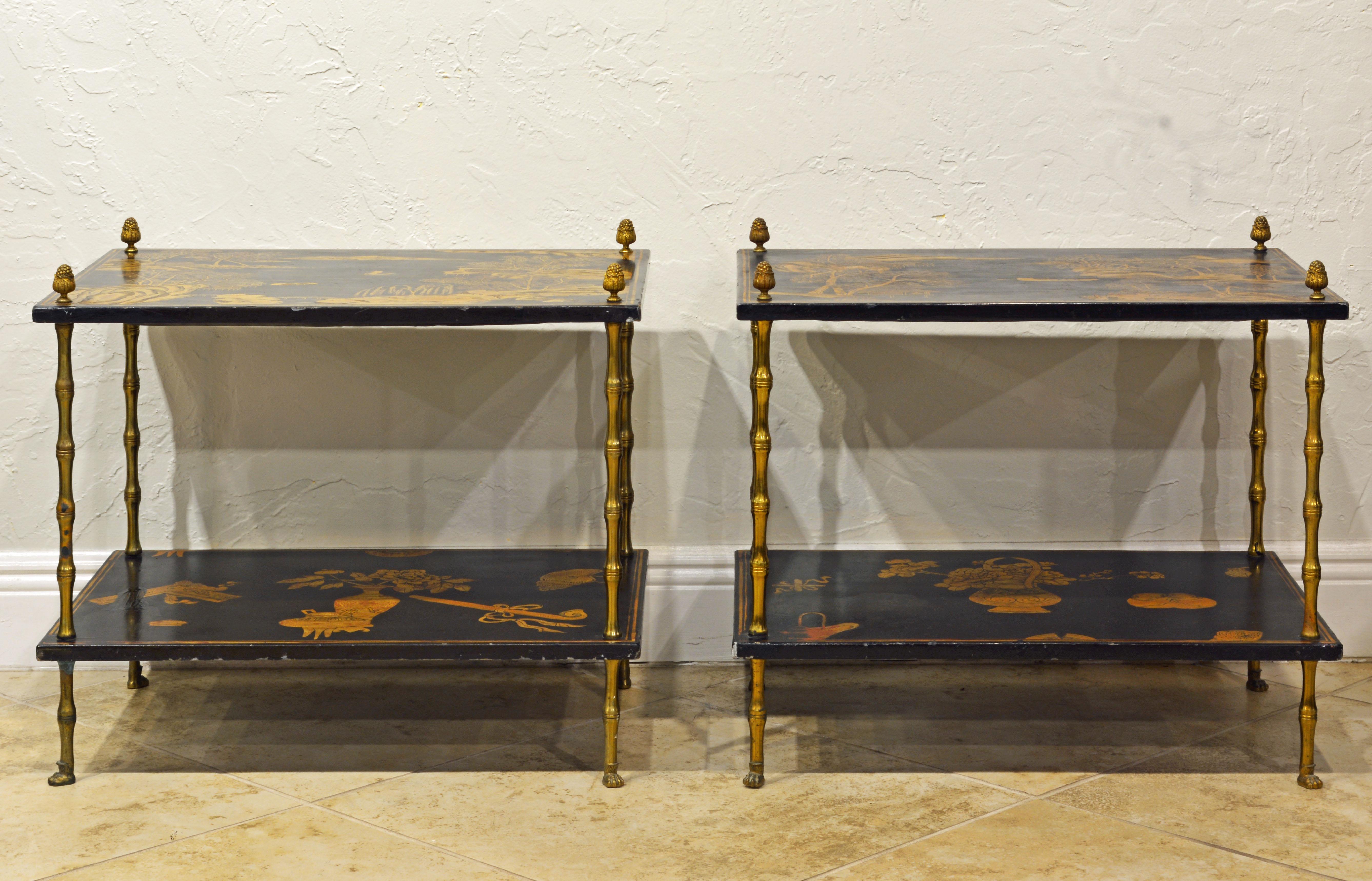 This fine pair of English Aesthetic Movement side tables in the Chinese taste date to the late 19th century and feature gilt decorated ebonized tops and lower shelves supported by faux bamboo brass legs topped by acorn finials and resting on paw