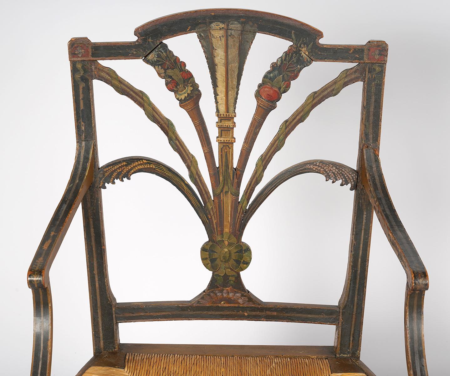 Creating a lovely countryside ambiance these painted rush seat regency chairs are richly decorated with flowers, sheafs of wheat, fruits, ribbons and on the center splat heraldic feathers, 19th century. The chairs date to circa 1830.
