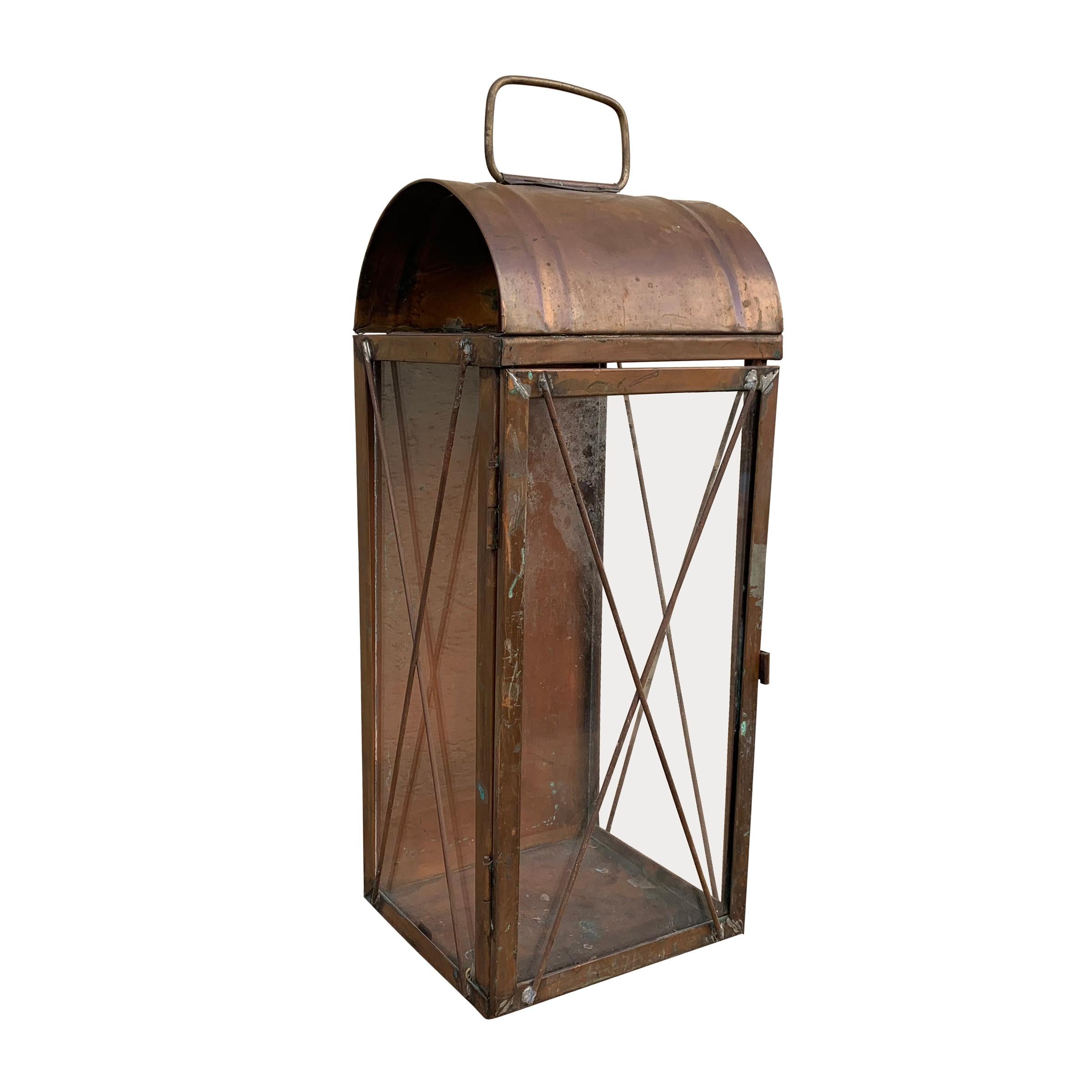 Pair of American copper candle lanterns with a three glass sides, a door on the front, and a vent at the top to allow the heat to escape.
