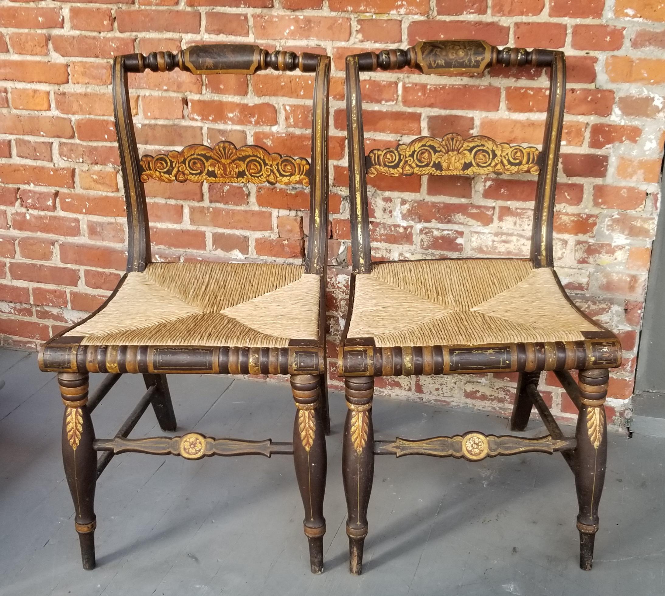 Pair of antique Hitchcock School side chairs featuring gilt stenciled decoration throughout and to include having newer rush seats, circa 1830. Very bold turning, the gold work on the splat and crest rail is lovely.
Very similar pair in the Henry