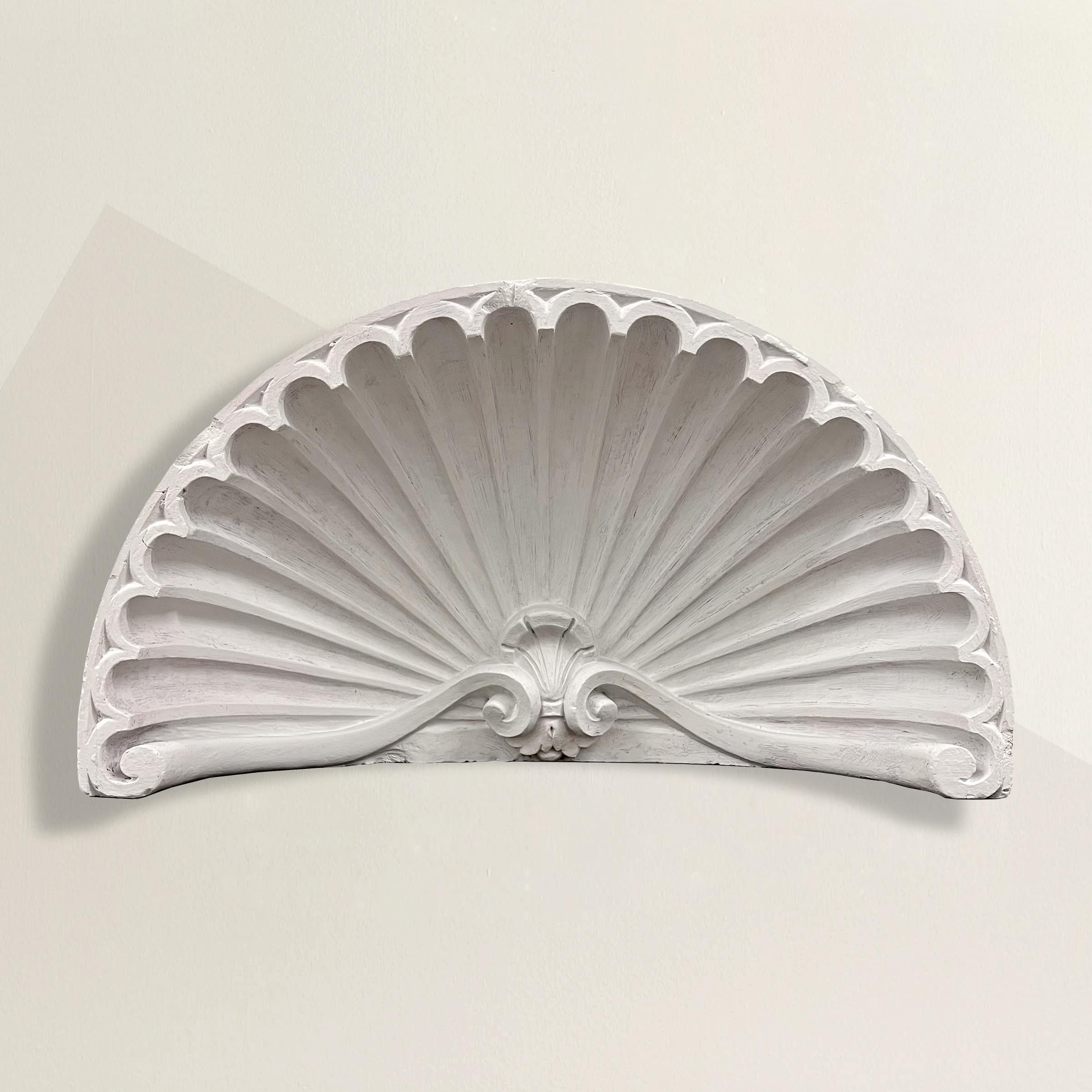 A striking pair of 19th century American plaster shell-form niche or door caps. These architectural fragments were originally mounted above niches or doors, and completed the classical architectural continuity of a room. Today, they're wonderful