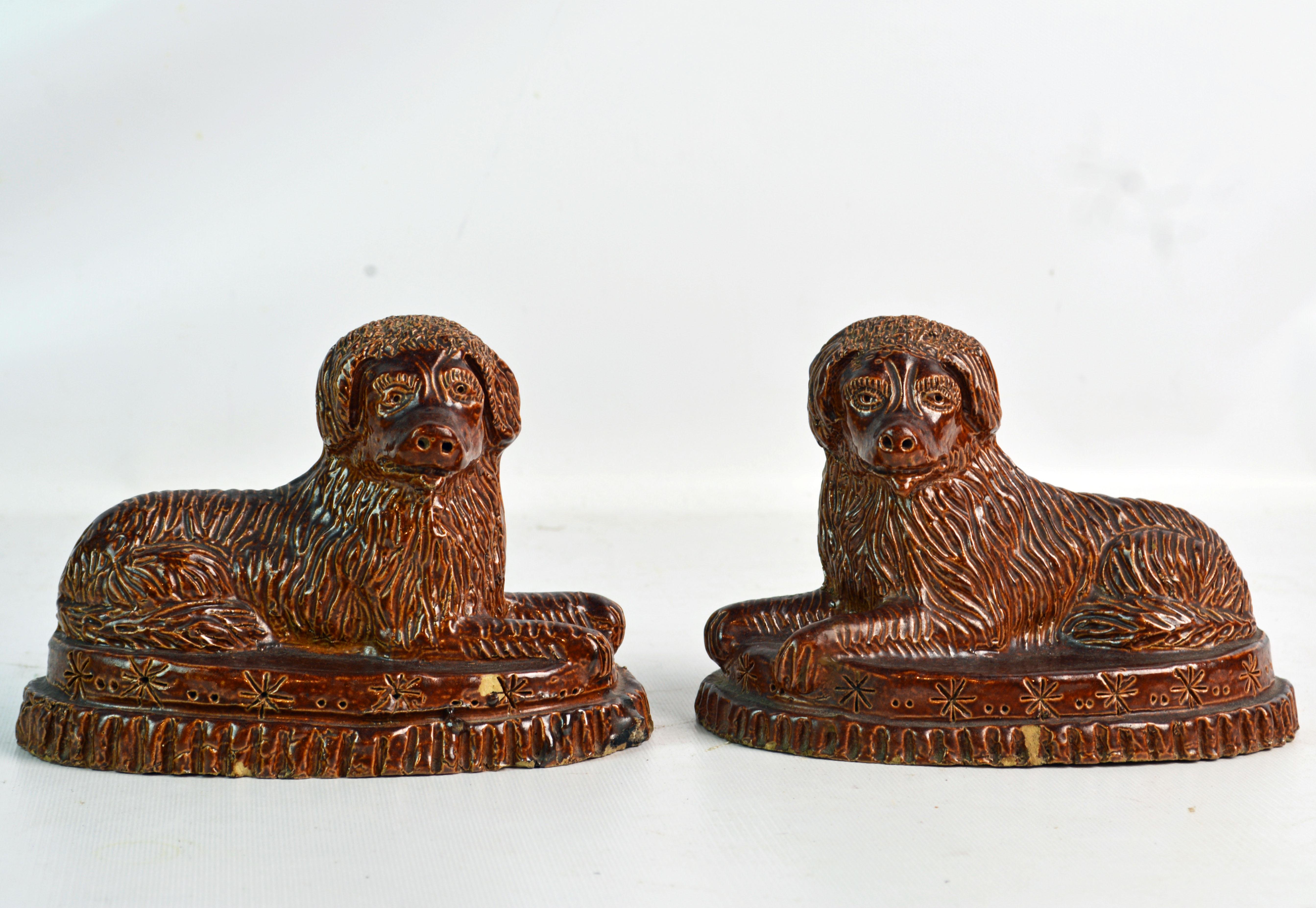 A wonderful matched pair of American mid-19th century yellow ware spaniels on oval decorated bases. Could be Virginia or Pennsylvania.