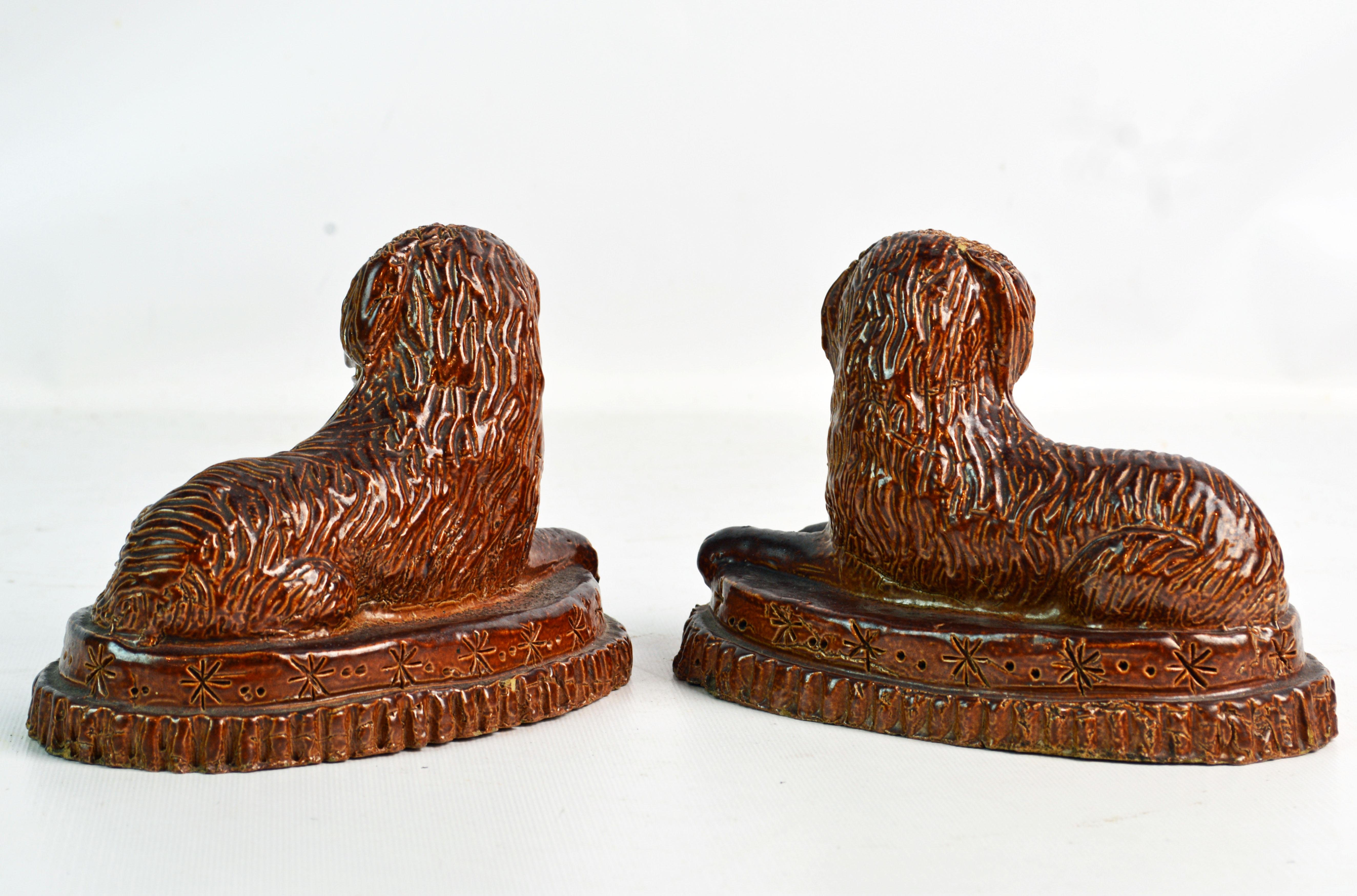 Glazed Pair of 19th Century American Yellow Ware Recumbent Spaniels on Oval Plinths