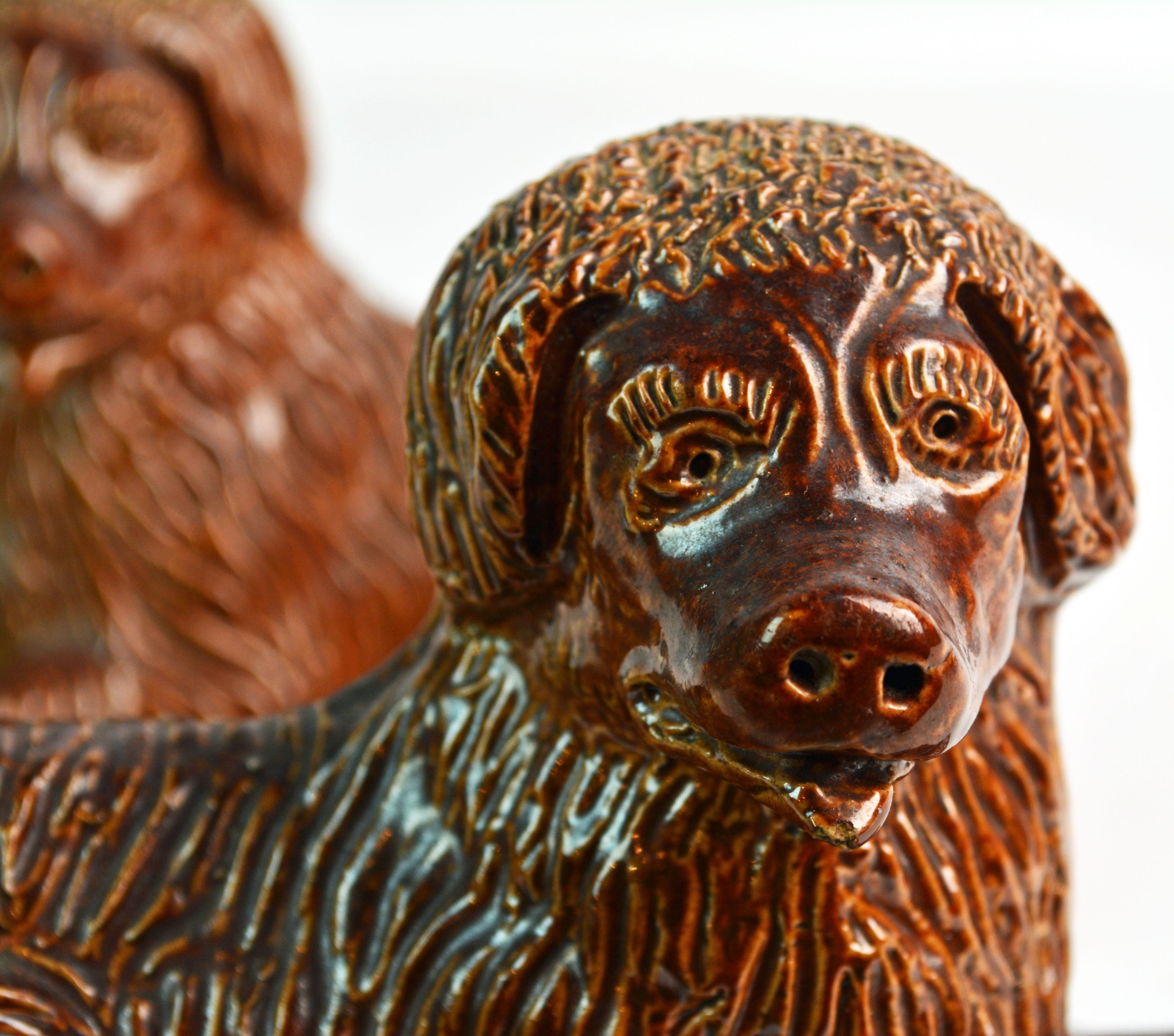 Stoneware Pair of 19th Century American Yellow Ware Recumbent Spaniels on Oval Plinths