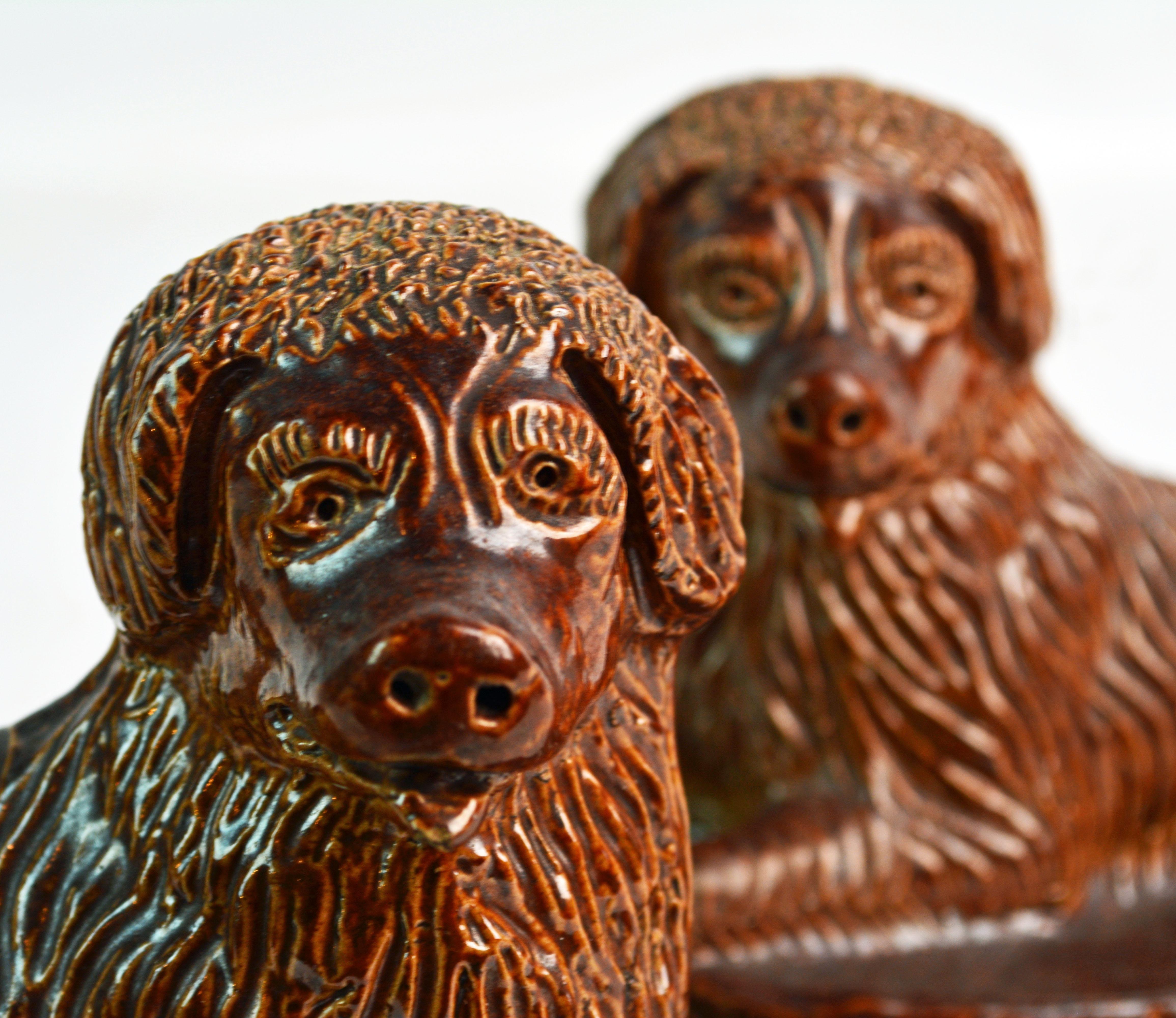 Pair of 19th Century American Yellow Ware Recumbent Spaniels on Oval Plinths 1