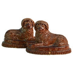 Pair of 19th Century American Yellow Ware Recumbent Spaniels on Oval Plinths