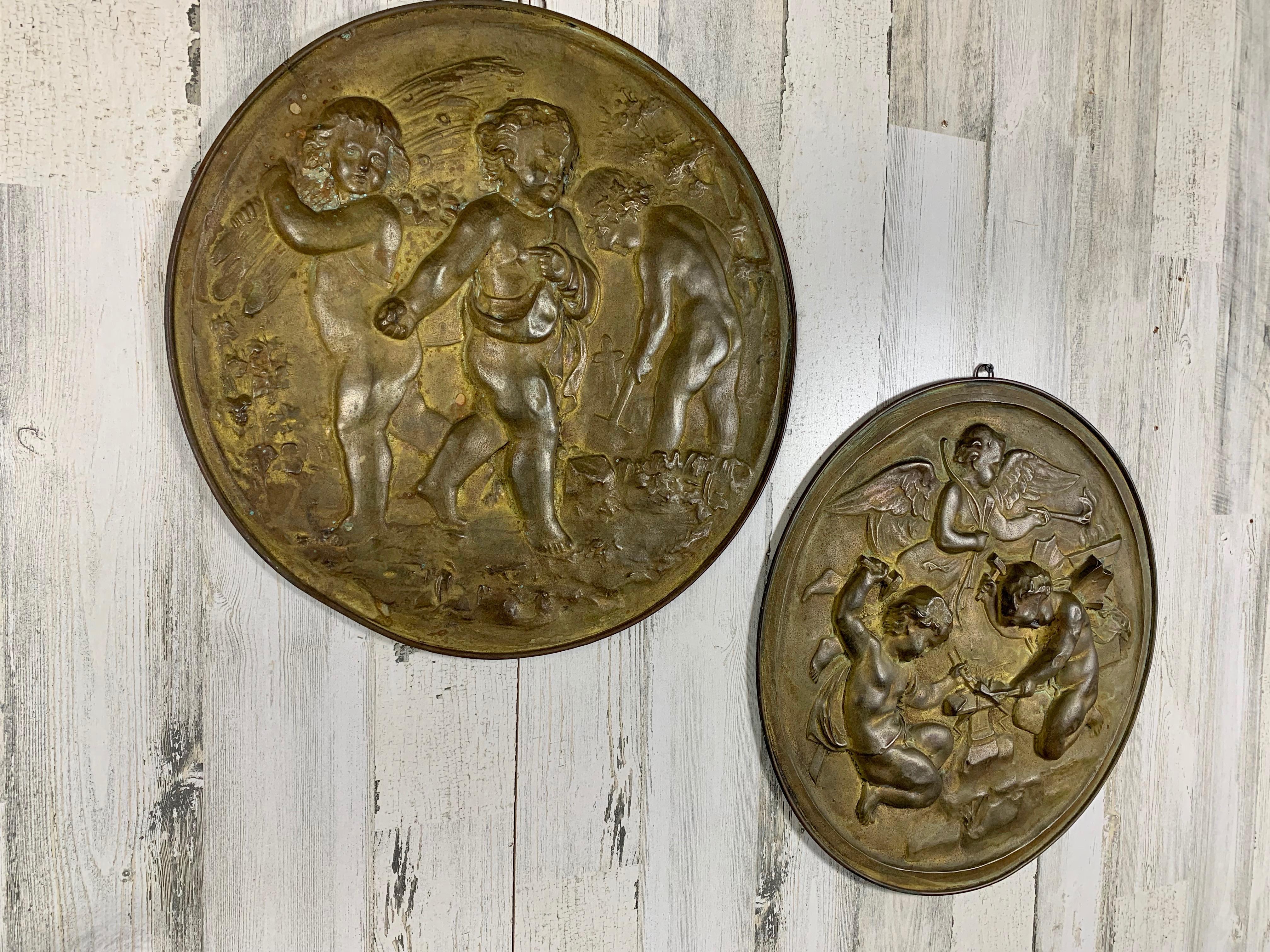 French Pair of 19th Century Angels at Work Brass Repousse Decorative Rounds For Sale