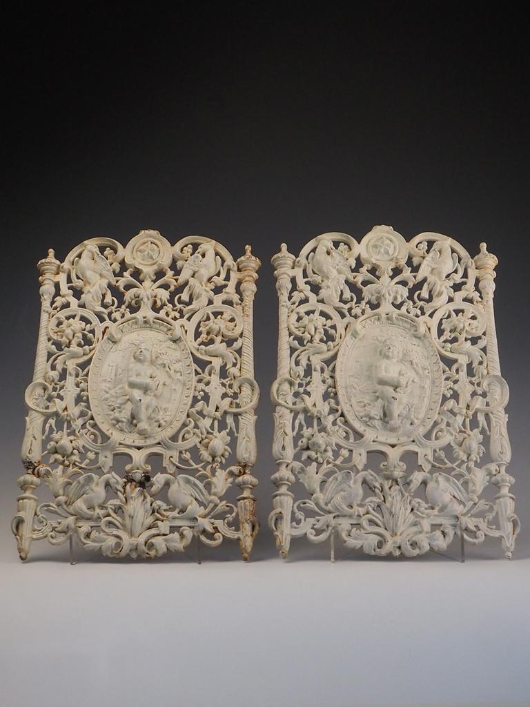 Pair of 19th Century Antique Cast Iron Decorative Wall Panels – Ornate Design

A beautiful pair of 19th century cast iron decorative panels, richly detailed and full of period charm. Each panel features an ornate central plaque depicting a putti