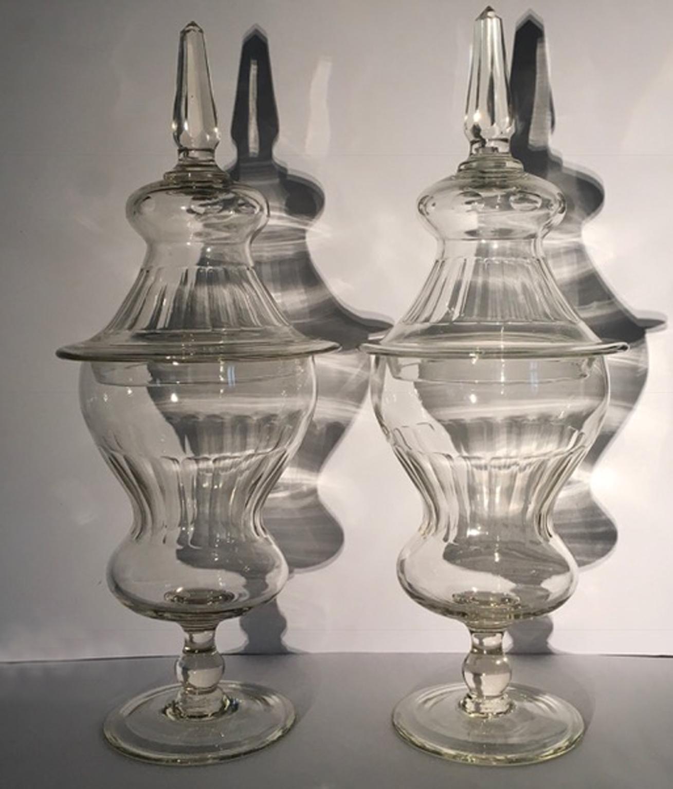 This wonderful and in perfect conditions pair of clear crystal vases with cover was manufactured in the ancient European country of Bohemia, well  known in the past for its beautiful crystal pieces.
The vases come from a palace in Rome (Italy),