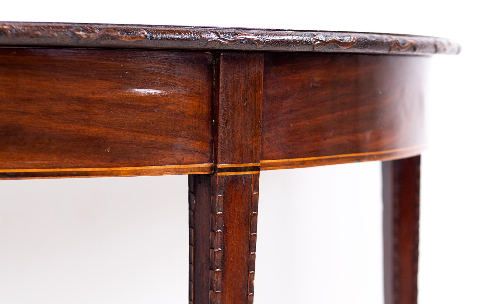 Pair of demi lune tables

A pair of Georgian early 19th-century demilune mahogany console side tables. This pair can be used as side tables or attached together to make a dining table.

Beautiful and detailed edging, tapered legs and spade feet.