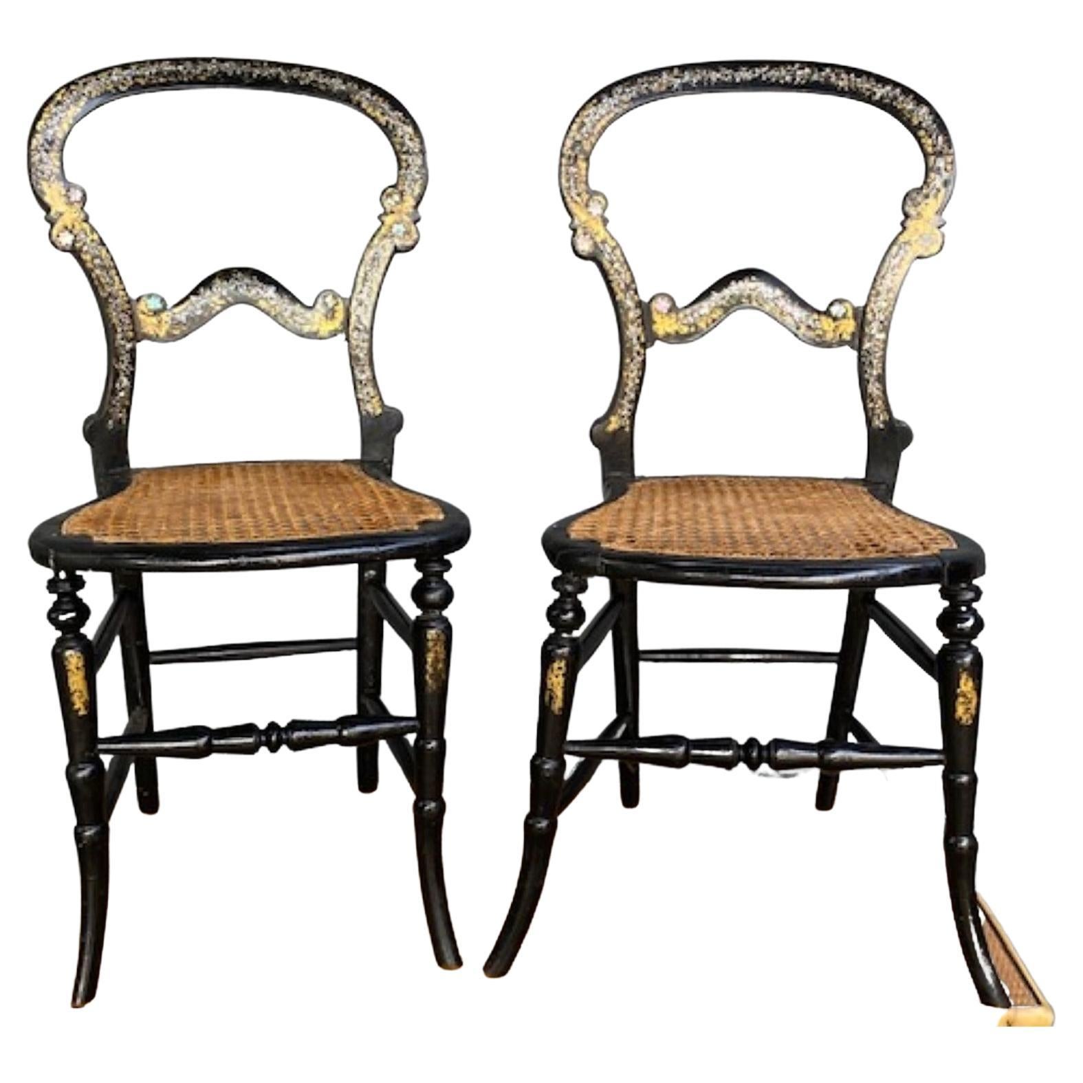 Pair of 19th Century. Antique English Ebonised Victorian Side Chairs

A beautiful pair of Victorian bergere.  Ebonised, mother of pearl; and gilt work, decorative show side chairs.  Rarely to be found in pairs. This pair has lovely mother-of-pearl
