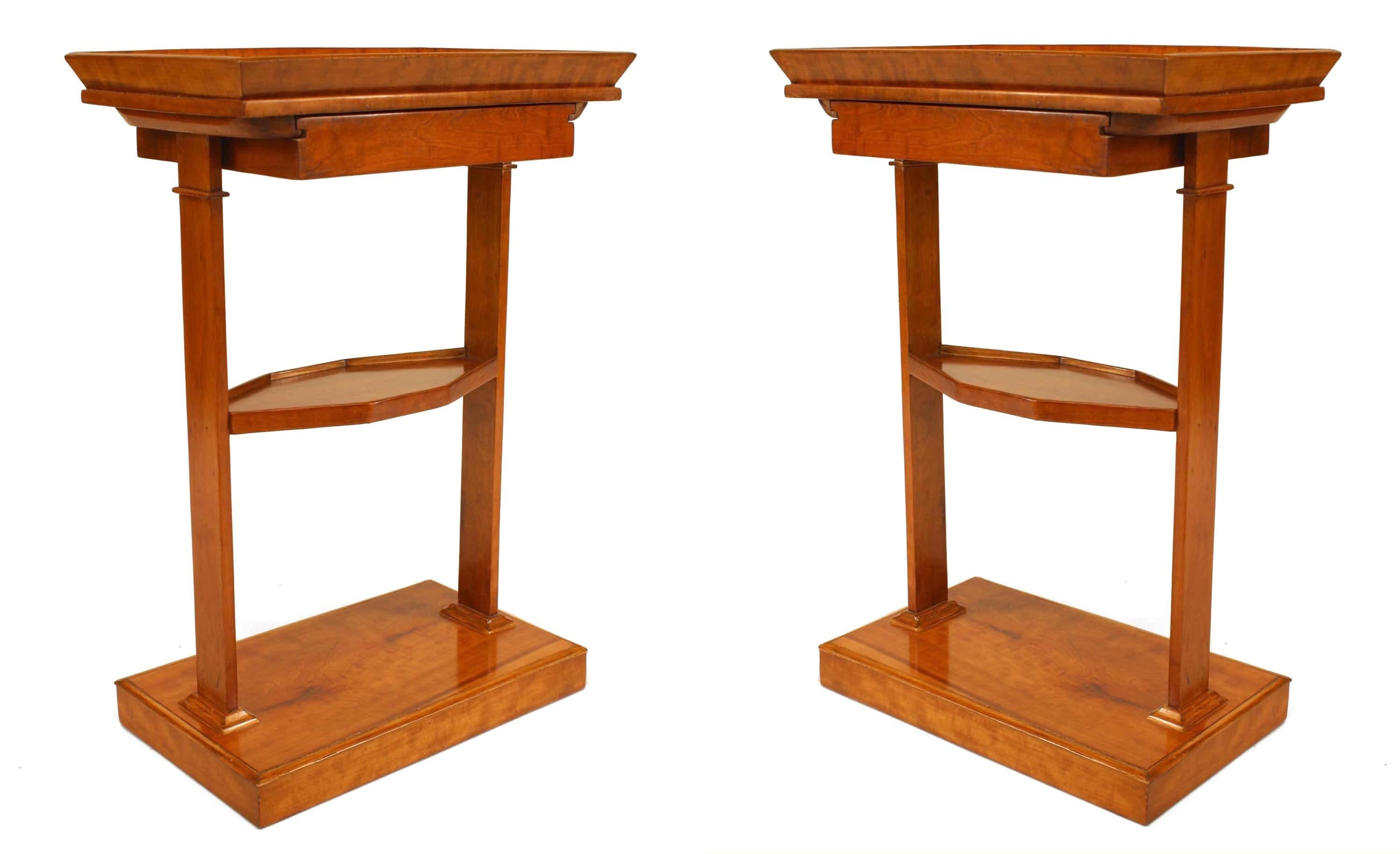 Pair of Austrian Biedermeier (19th Century) cherrywood rectangular end tables with a gallery top and a drawer with a center shelf supported on a platform base. (PRICED AS Pair)
