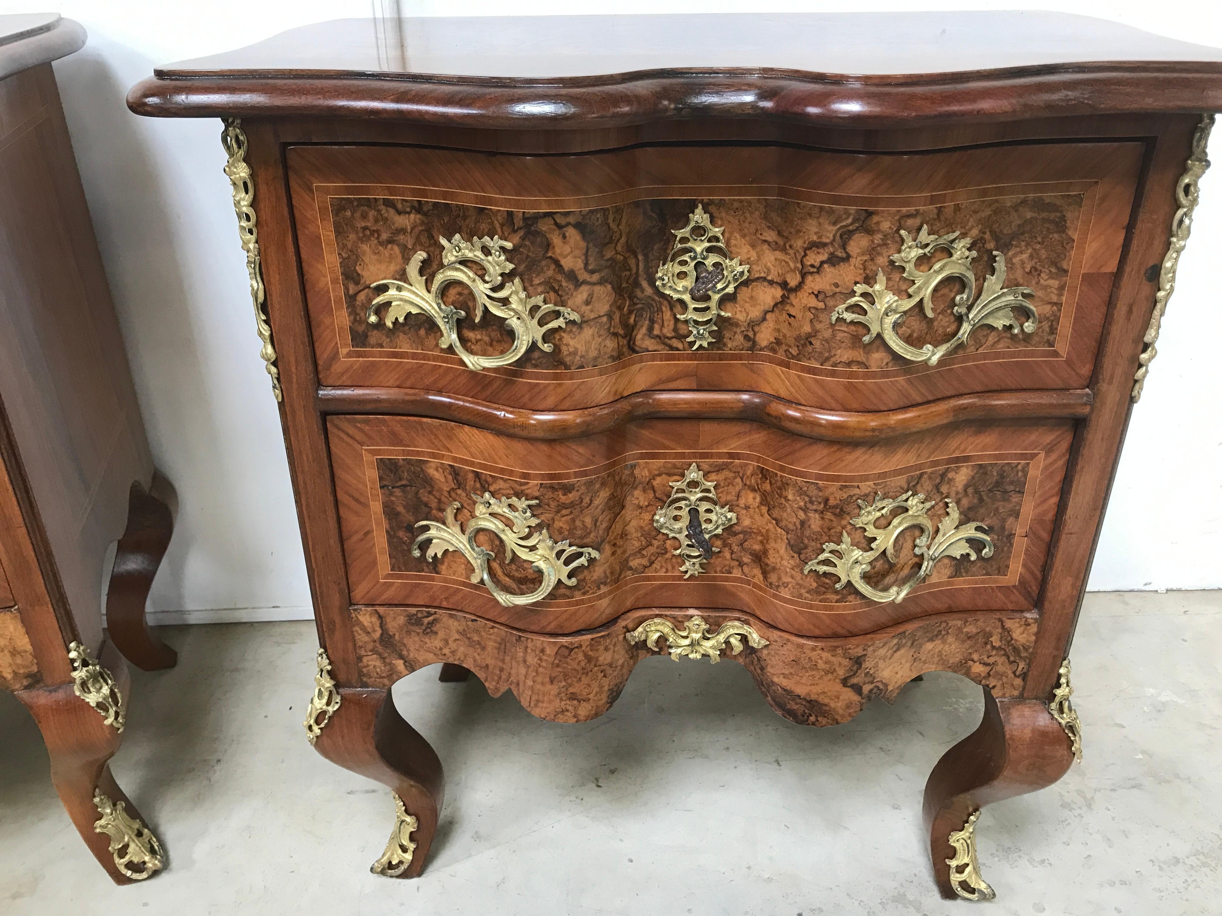 A fine pair of 19th century walnut baroque commodes. Of small size, lovely use of walnut timbers using burr walnut, kingwood and box wood. With all original ormolu mounts and keys. All cleaned and polished, and looking stunning.