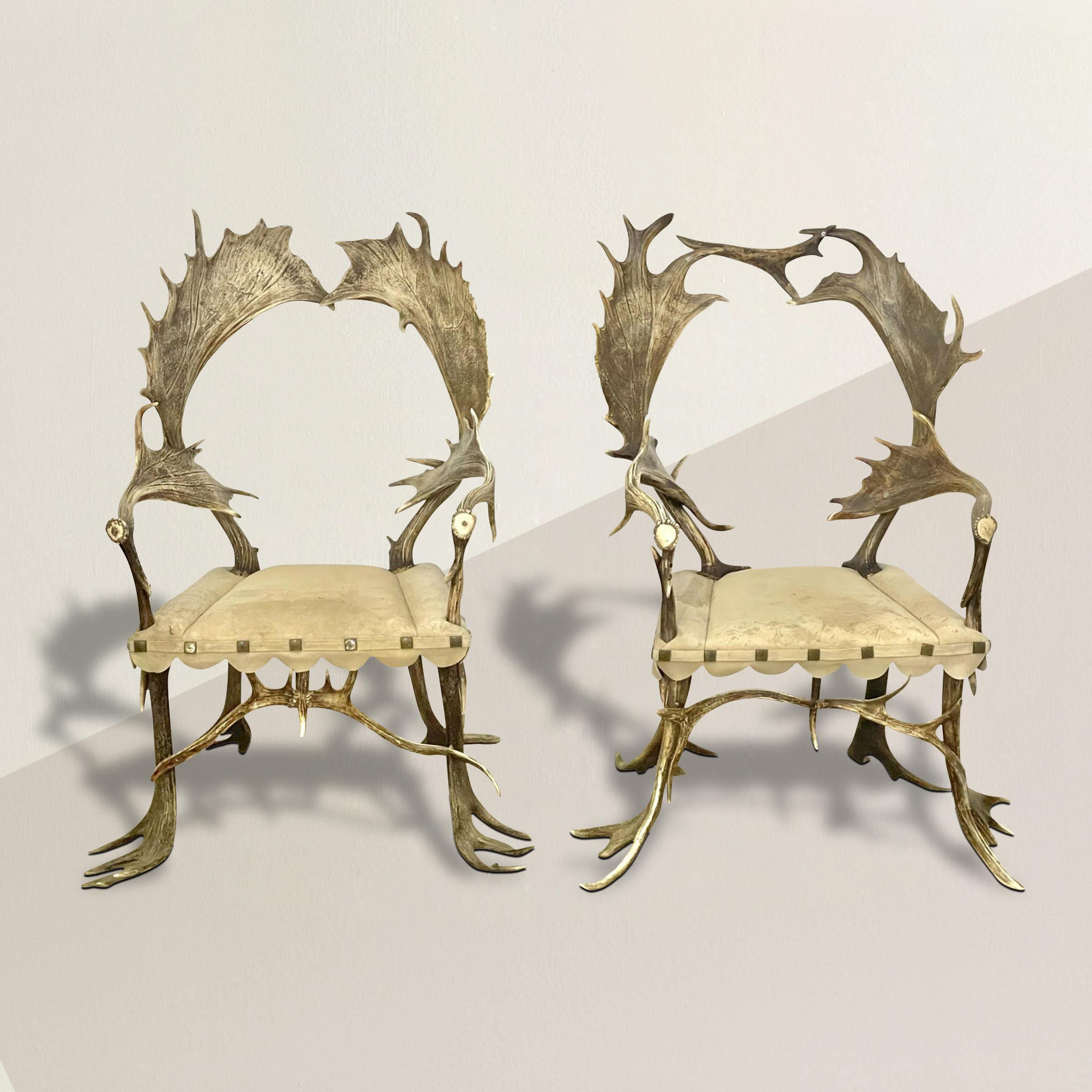 An incredible pair of 19th century Bavarian hunting lodge armchairs with backs, arms, and legs constructed from Fallow Deer antlers, and upholstered in cream colored suede with square nailhead trim. Perfect for your mountain home, hunting lodge, or
