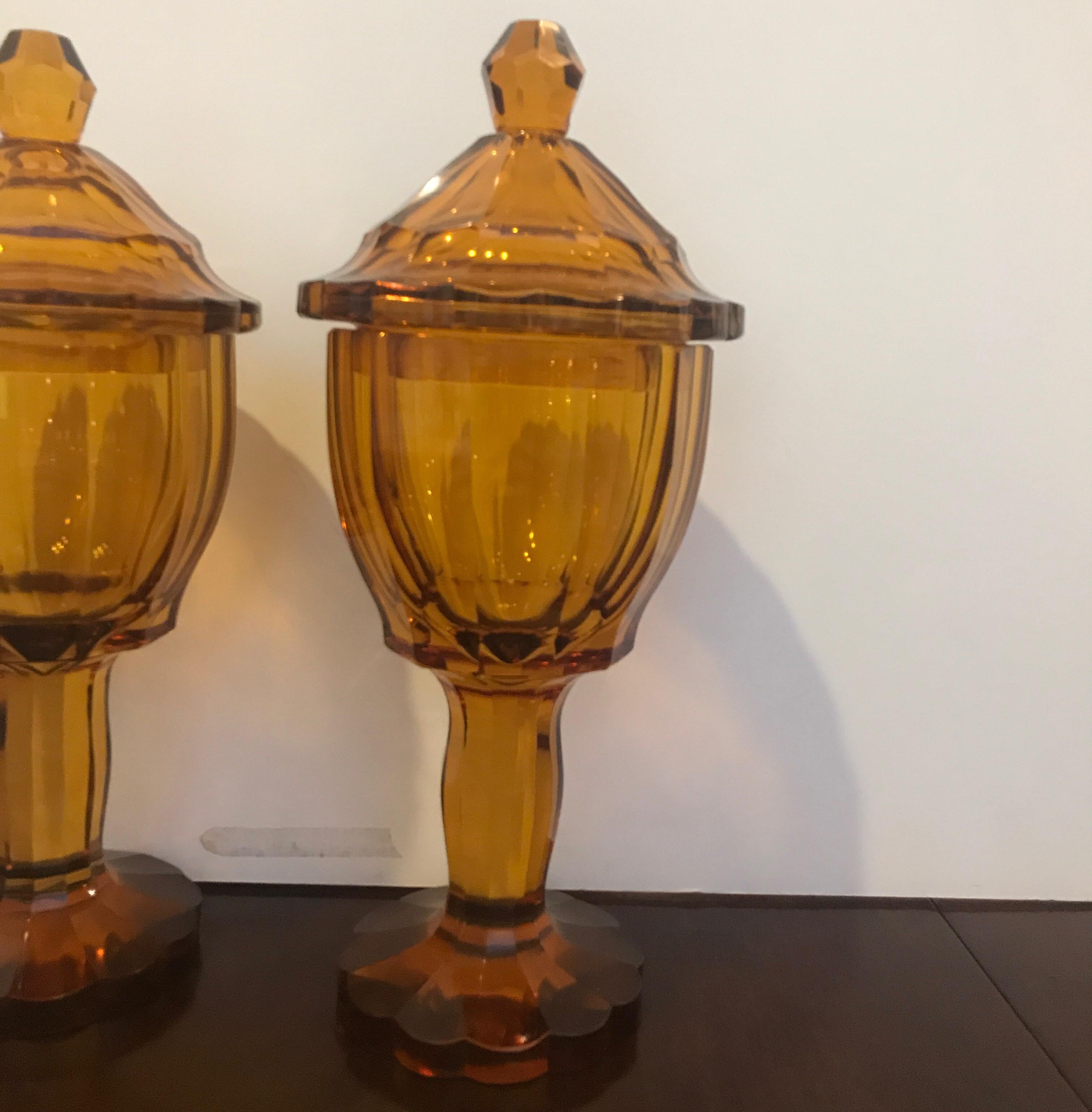 Handsome pair of Austrian panel cut glass covered chalices. The polished panel cuts start at the top of the lids and follow down the chalice bowls down to the pedestal bases. Each one is hand blown, handcut and polished on a wheel with the polished