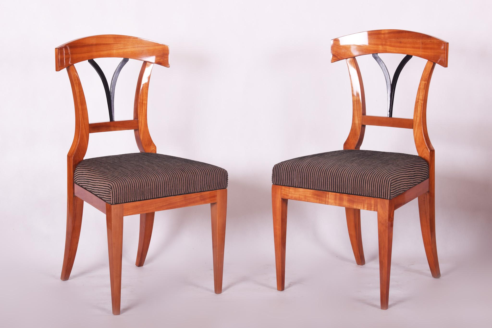 The chairs have been fully restored and are made out of cherry wood.