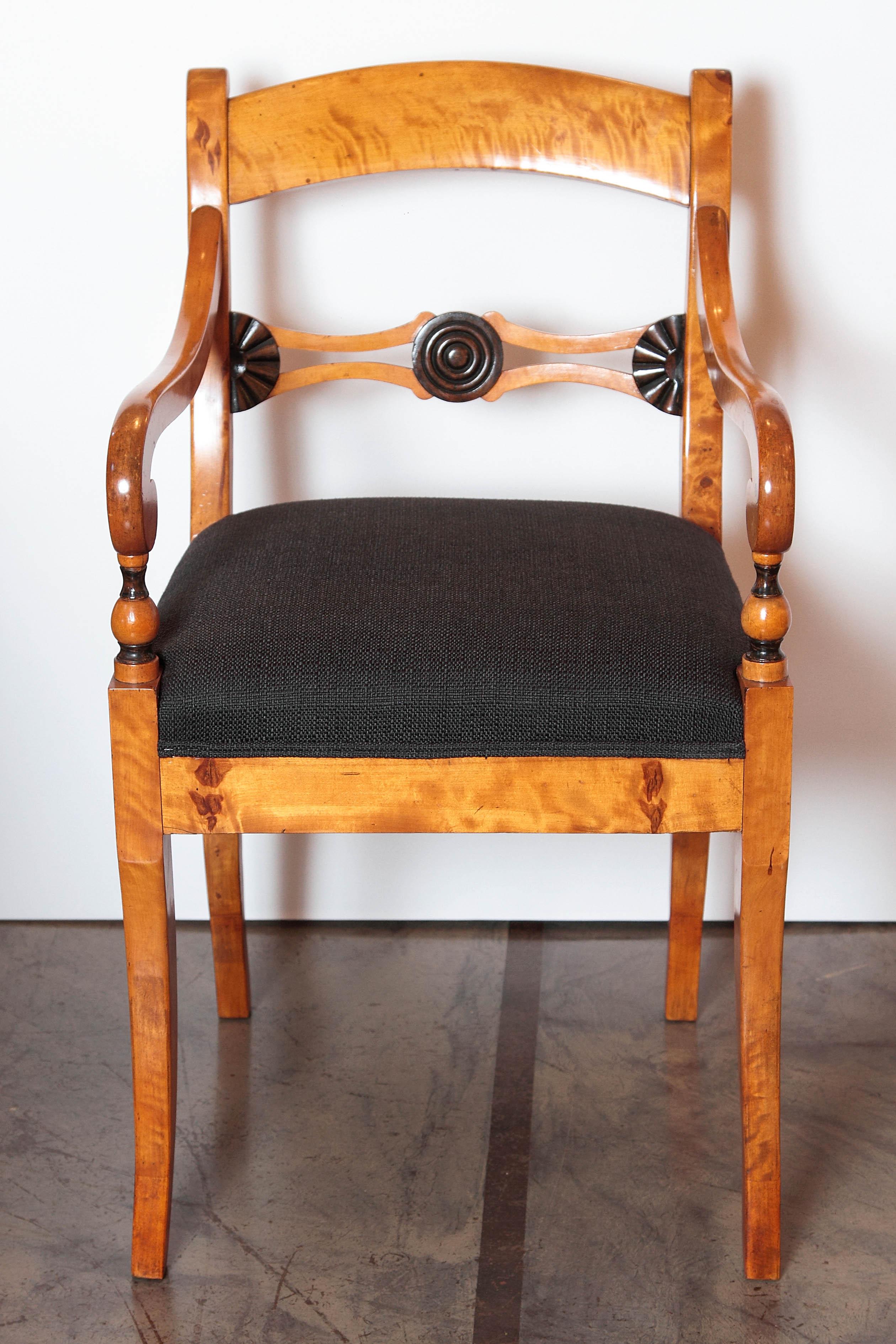 Pair of 19th century Biedermeier satinwood birch and ebonized open armchairs.
