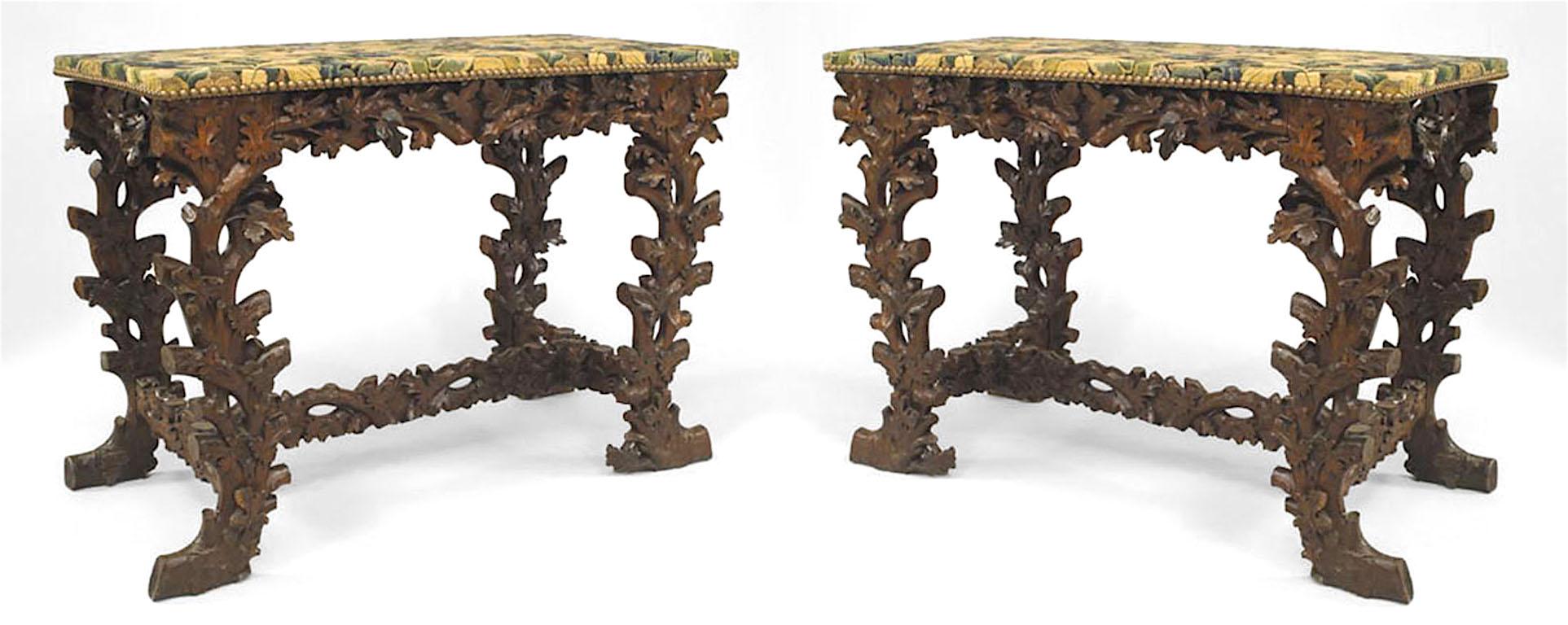 Pair of Rustic Black Forest (19th Century) walnut console tables with floral carving and stretcher with tapestry covered tops. (PRICED AS Pair)
