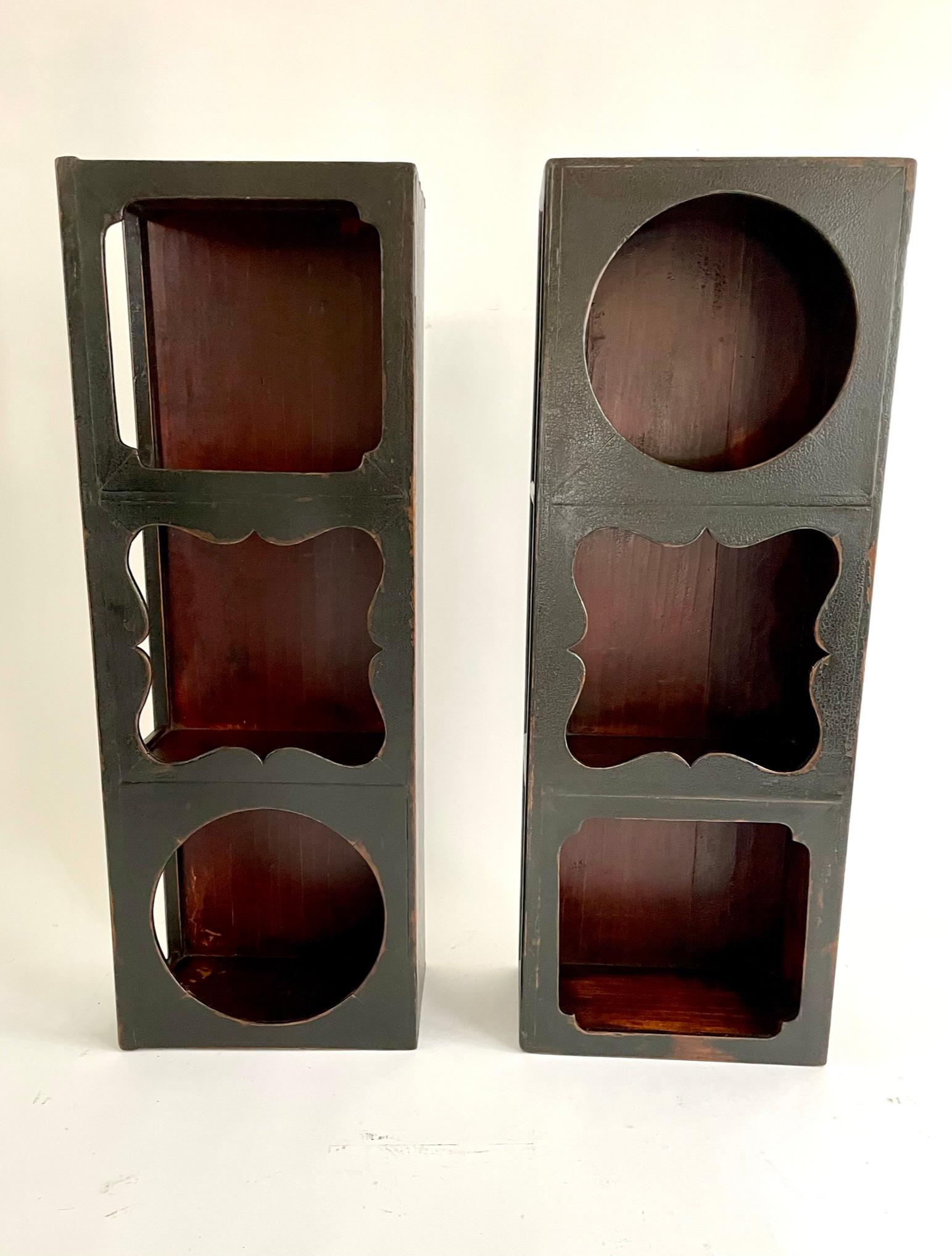 This beautiful pair of unusual Chinese scholar shelves is finely crafted with Chinese Northern Elmwood and finished with a black lacquer. The wood is jointed together with Chinese traditional joinery which uses no glue or nails. The insides of the