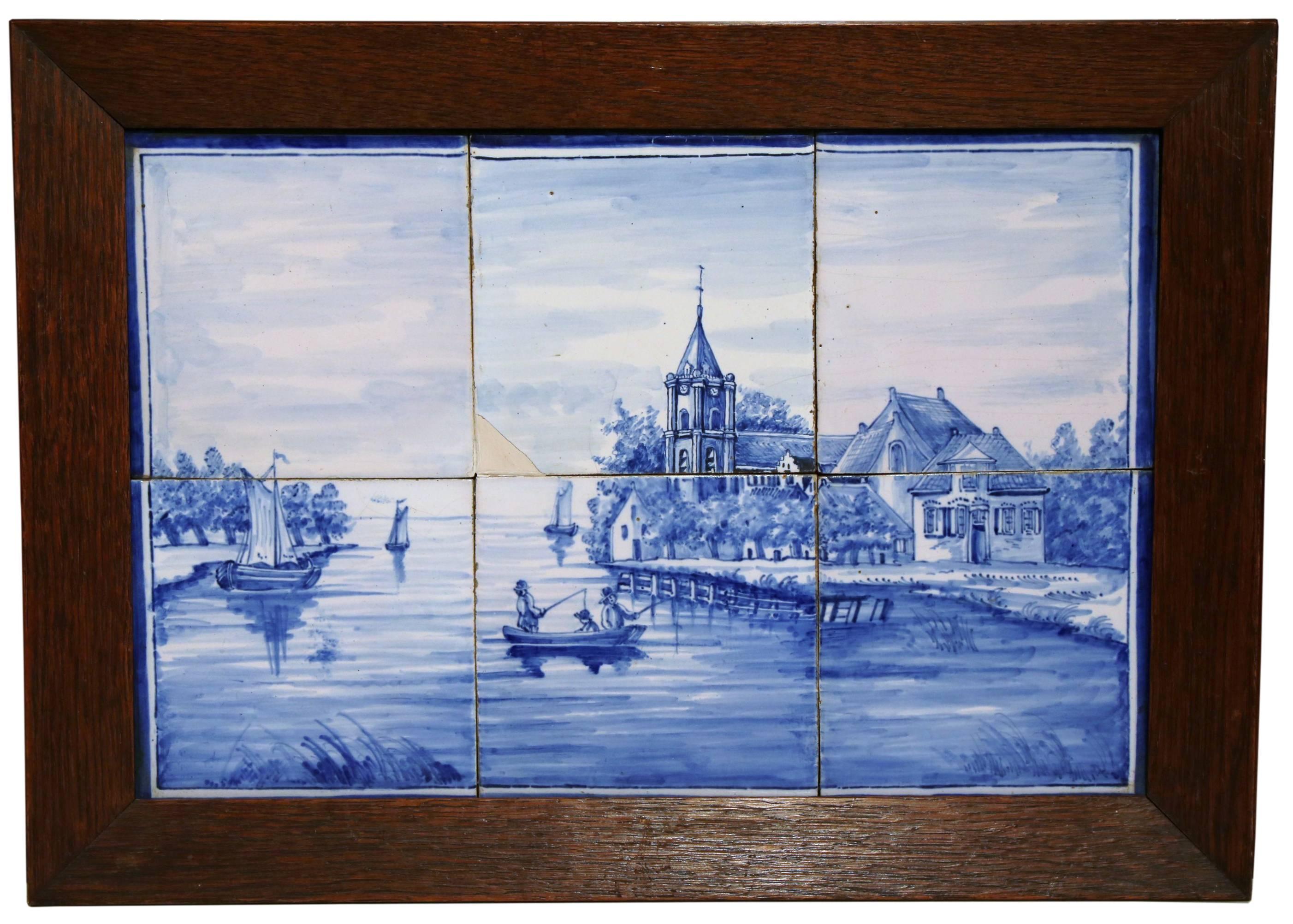 The elegant antique ceramic tiles were created in France, circa 1860. Each wall decor is set inside a carved oak frame, and features six hand painted porcelain faience tiles with illustrations typical of the traditional delft style and coloration;