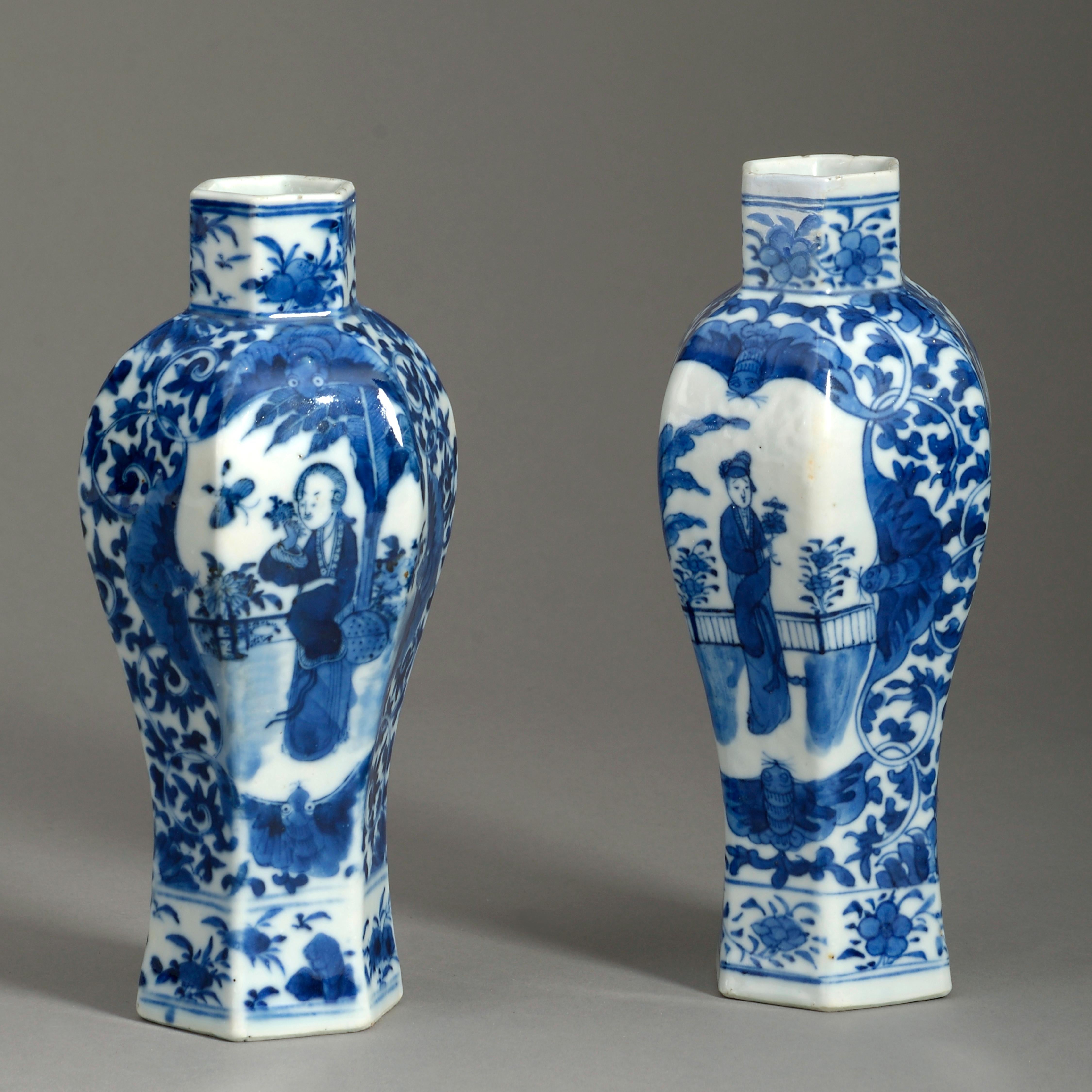 A 19th century pair of small scale blue and white glazed porcelain vases in the Kangxi taste, of hexagonal baluster form and decorated with figurative cartouches upon a foliate ground.

Qing dynasty

One neck restored.

 