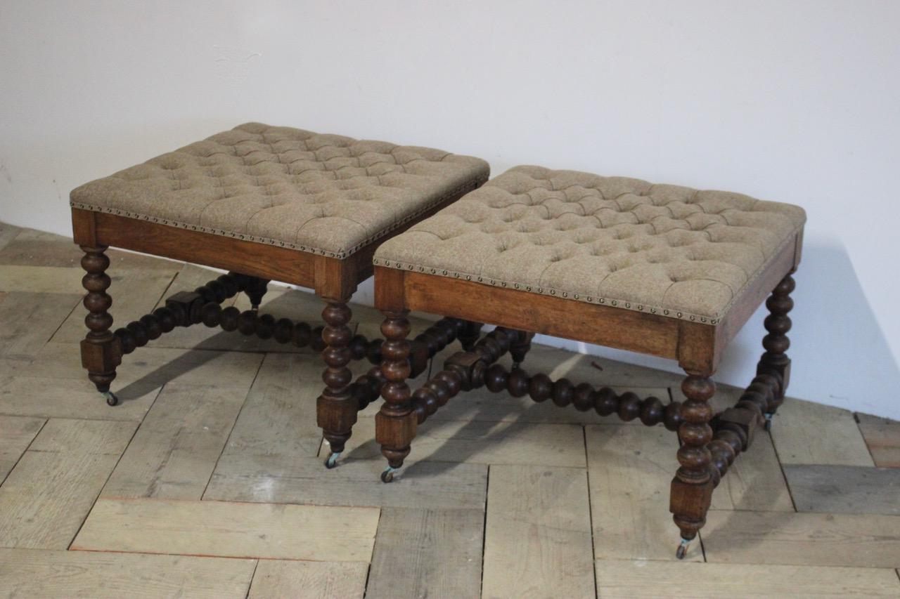 A good pair of 19th century English Country House bobbin turned oak stools, having been reupholstered by us in wool, that will work well also as a coffee table.
 
