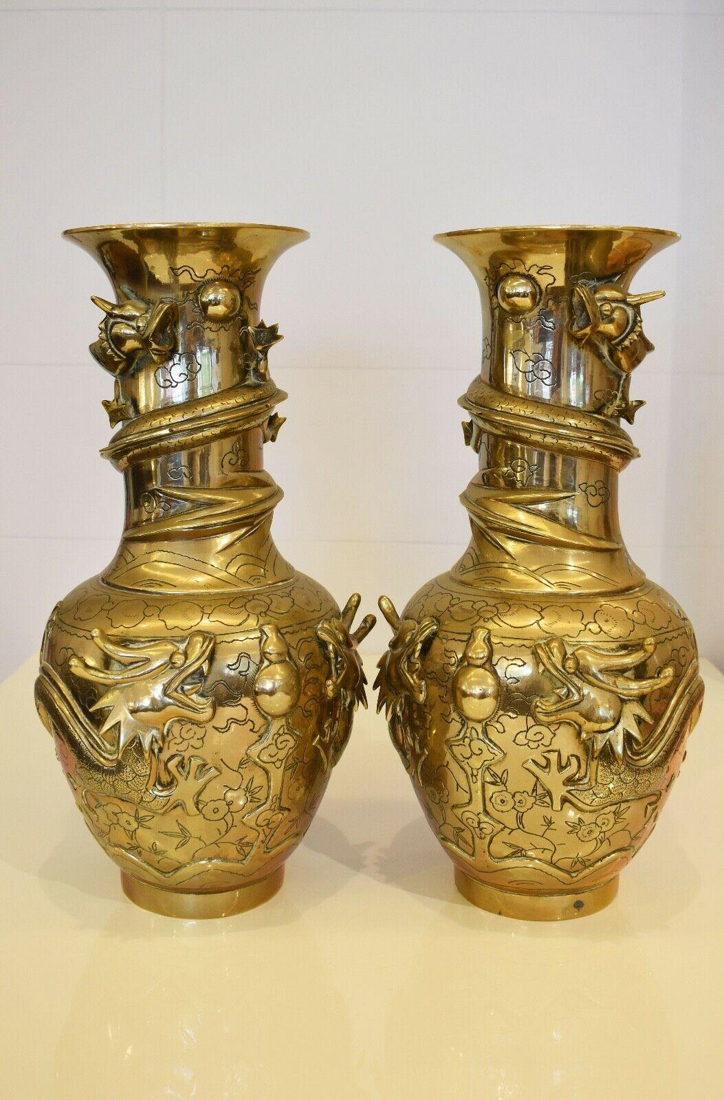 A superb pair of rare 19th century Chinese brass vases with ornate dragon figures emerging from the surface and carved detailing throughout. 

High quality rare pieces, both stamped heavily to the base.
