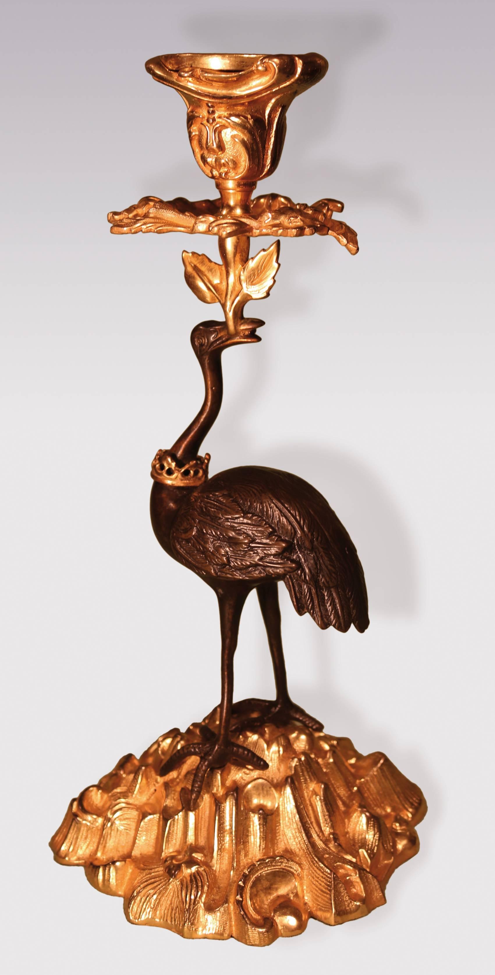 A pair of mid-19th century bronze and ormolu candlesticks, having Rococo candleholders, above well-cast storks, with distinctive crowns to their necks, raised on rock and shell bases.
(Probably by Thomas Abbott of Birmingham.)