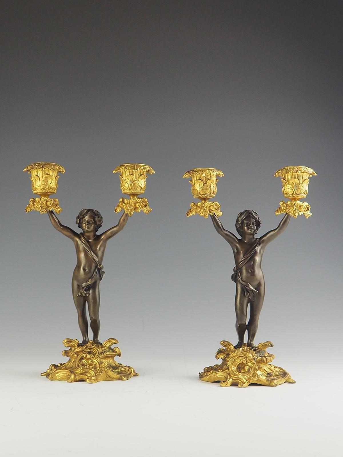 Gilt Pair of 19th Century Bronze and Ormolu Twin-Light Cherub Candelabra For Sale